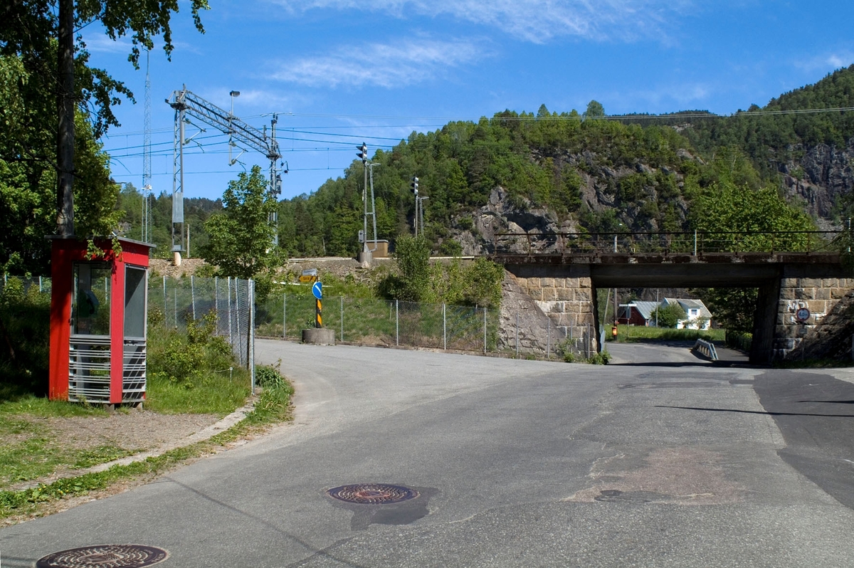 This is the story of how Norway’s most important conversation-space was designed by a young, freshly graduated man from Bergen.

“Norwegian architects are hereby invited…”
In the autumn of 1932, Oslo Telefonanlegginitiated an architectural competition. Finally, Oslo would get its own telephone booth. The city had had so called “talking-stations” from 1885, which in turn were overtaken by automatic telephones 
 only available at selected Narvesen kiosks. The state 
was of the opinion that now was the time to offer the public a better service; public telephone booths open 24/7, like the ones they already had in Sweden and England. But what would they look like, these new telephone booths? What considerations would it
 be necessary to take when designing it? The telegraph board developed a detailed list of demands and restraints: “The booth is intended to be placed outside on the streets and squares and need to be designed so that snow and ice does not hinder the opening and closing of the doors,” they wrote. “To prevent vandalism, theft, uncleanliness etc. inside the booth, it needs to be designed so that from all angles one may see what is going on in there.” Additionally, it would need to withstand storms and bad weather, and “preferably also being whipped by rain mixed with seawater” 

This was not all: The appearance would have to be «pleasing». The booth also needed to be movable, so that it could be taken in to be serviced at Telegrafverket’s main workshops. The reqired material was iron, and the surface was to be spray painted  preferably using car-body paint. There was a requirement for “a writing shelf, a pack shelf, and a suitable place for the telephone catalogue.” Also, there would need to be an illuminated TELEFON  sign, easily visible from all four angles. The total cost for each booth should not exceed 1000 kroner. The first prize for coming up with such a product was 800 kroner.

“Norwegianarchitects are hereby invited to partake in a competition for the design of a telephone booth…”  

The man with the solution
«At some point in 1932, Georg Fredrik sat at a party in Bergen. Maybe he felt a bit lost and forgotten as he often had throughout his life. He retreated to a quiet corner, took out a pencil and strted doodling on a matchbox.  According to my mother, this was how the telephone booth came into being.” In the book “Norges lille røde  historien om telefonkiosken,” Lars Fasting describes his father, the man who is far less known than the iconic architctural structure he left behind. Georg Fredrik Fasting was from Bergen, born into a family of working people and smallholders. One unusual facet of Georg Fredrik was that he was born without ears. His mother made sure he learnt to speak, read and write, 
ut Lars Fasting indicates that his father would seek refuge in drawing when the social challenges became too much to bear. And in the end drawing became his profession. In 1924 he secured a guarantor for a student loan, and started studying to become an a
rchitect at the NTH. Throughout the 1930s he entered several architectural competitions, with drafts produced, according to his son, “after work and in the late hours of the night.”

His efforts were not wasted. Out of 93 entries, with names such as “Flirt”, “Brrr”, “Ring” and “Amor”, the jury selected Fasting’s submission, “RIKS” as the new telephone booth: “The draft shows a strikingly simple solution to the task, technically as well as aesthetically well worked out.”

Taut and provident
Simple and aesthetc are the keywords here. Fasting had designed a booth pointing towards the future, and to modernism. Just how modern it was can be seen by comparing RIKS to the British telephone booth, also designed in the interwar-era. While the British version with it classicistic style is looking back to the heyday of the empire, Fasting’s booth is progressive and functionalistic. Like most Norwegian architects, Fasting broke with the classicistic style of architecture after the Stockholm-exhibition in 1930. “After it, almost all buildings erected in Norway until the German invasion in 1940, were in the functionalistic architectural style,” writes senior curator of architecture at the Norwegian National Museum, Ulf Grønvold, in the book, “Den lille røde”.“TheNorwegian booth is a piece of functionalistic architecture, an asymmetric composition with its roof slab overhanging the word TELEFON, in bold sans seraph lettering,”concludes Ulf Grønvold.

Fashionably red
And it was red. Fasting chose a colour which was part of the modern palette. “A bright red colour, but not as shiny as a signal red, the character of the colour places it among the fashionable colours within functionalism,” states paintings conservator and researcher in NIKU (Norwegian Institute for Cultural Heitage Research), Jon Brænne. In his opinion, Fasting went for visibility without making the booth stand out too much from its surroundings. The original colour was in use up to around 1950, when it changed to signal red. Towards the end of the 1970s the clour was again adjusted towards today’s orangey red.

The design, however, has not changed. RIKS is eighty years and still looks remarkably good. That’s what makes Fasting’s telephone booth a classic  even before it was added to DOCOMOMO’s list over moden icons of design. For Telenor, the telephone booth has served as a pathway into the hearts of the public. For many, Telenor (Televerket) was synonymous with exactly this telephone booth, because this was where one would go to place a call. Having a home
phone was not common until the 1980s. As such the red box became part of the Norwegian everyday and consciousness. The symbol- and publicity value of this is hard to evaluate, but in 2007 it was time to give honour where honour was due, Telenor, in consul
tation with the Directorate for Cultural Heritage, decided to preserve 100 telephone booths for all eternity.

And what about Georg Fredrik Fasting? What happened to him? At the age of 56 an entry in his diary states: «I CAN HEAR». As the first person in th world he had undergone an operation where he had ear canals constructed and eardrums fitted. For the rest of his life, the man behind Norway’s own telephone booth could answer the telephone himself.

Source: Norges lille røde historien om telefonkiosken (2007), issued by The Norwegian Telecom Museum and Telenor Cultural Heritage.