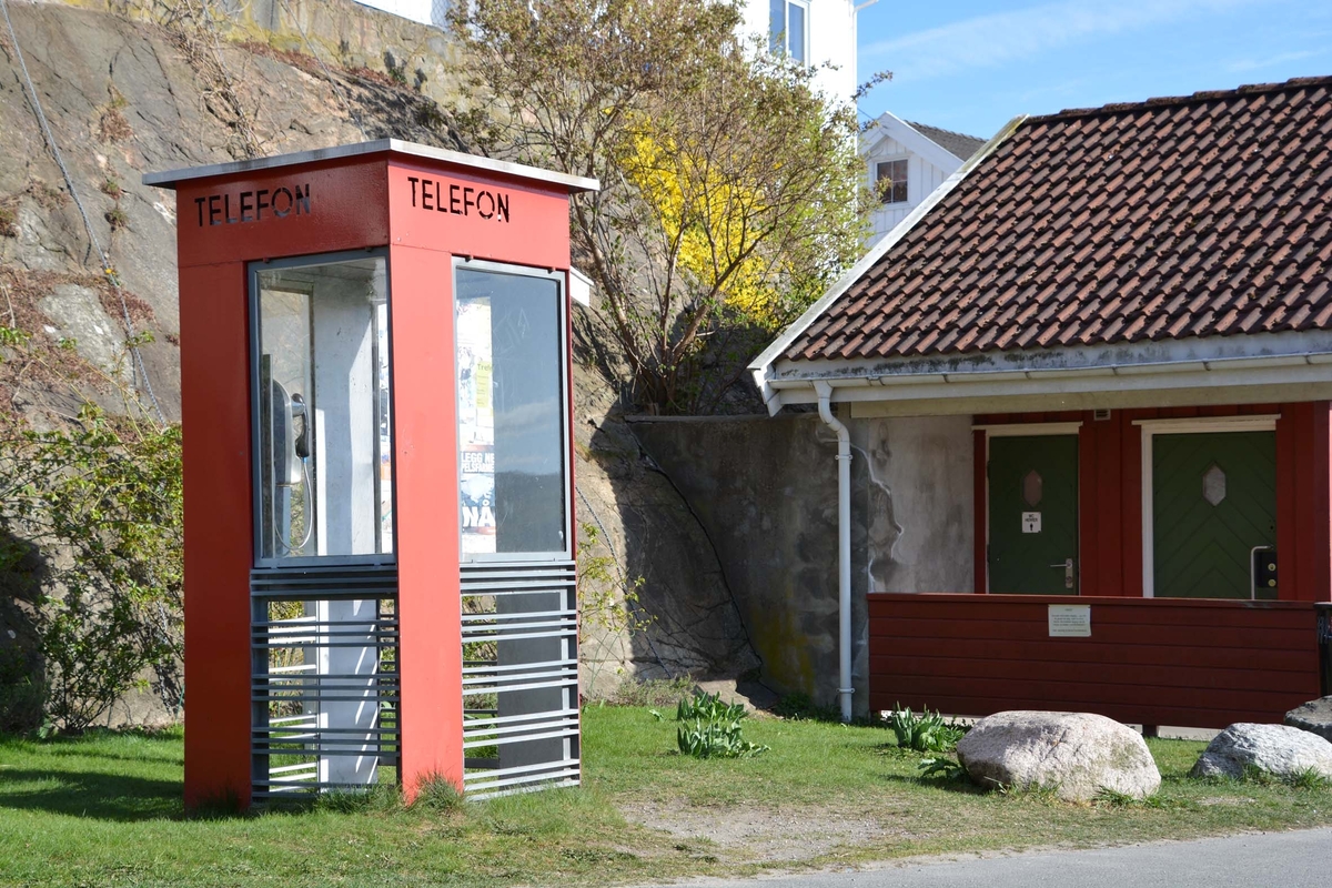 This is the story of how Norway’s most important conversation-space was designed by a young, freshly graduated man from Bergen.

“Norwegian architects are hereby invited…”
In the autumn of 1932, Oslo Telefonanlegginitiated an architectural competition. Finally, Oslo would get its own telephone booth. The city had had so called “talking-stations” from 1885, which in turn were overtaken by automatic telephones 
 only available at selected Narvesen kiosks. The state 
was of the opinion that now was the time to offer the public a better service; public telephone booths open 24/7, like the ones they already had in Sweden and England. But what would they look like, these new telephone booths? What considerations would it
 be necessary to take when designing it? The telegraph board developed a detailed list of demands and restraints: “The booth is intended to be placed outside on the streets and squares and need to be designed so that snow and ice does not hinder the opening and closing of the doors,” they wrote. “To prevent vandalism, theft, uncleanliness etc. inside the booth, it needs to be designed so that from all angles one may see what is going on in there.” Additionally, it would need to withstand storms and bad weather, and “preferably also being whipped by rain mixed with seawater” 

This was not all: The appearance would have to be «pleasing». The booth also needed to be movable, so that it could be taken in to be serviced at Telegrafverket’s main workshops. The reqired material was iron, and the surface was to be spray painted  preferably using car-body paint. There was a requirement for “a writing shelf, a pack shelf, and a suitable place for the telephone catalogue.” Also, there would need to be an illuminated TELEFON  sign, easily visible from all four angles. The total cost for each booth should not exceed 1000 kroner. The first prize for coming up with such a product was 800 kroner.

“Norwegianarchitects are hereby invited to partake in a competition for the design of a telephone booth…”  

The man with the solution
«At some point in 1932, Georg Fredrik sat at a party in Bergen. Maybe he felt a bit lost and forgotten as he often had throughout his life. He retreated to a quiet corner, took out a pencil and strted doodling on a matchbox.  According to my mother, this was how the telephone booth came into being.” In the book “Norges lille røde  historien om telefonkiosken,” Lars Fasting describes his father, the man who is far less known than the iconic architctural structure he left behind. Georg Fredrik Fasting was from Bergen, born into a family of working people and smallholders. One unusual facet of Georg Fredrik was that he was born without ears. His mother made sure he learnt to speak, read and write, 
ut Lars Fasting indicates that his father would seek refuge in drawing when the social challenges became too much to bear. And in the end drawing became his profession. In 1924 he secured a guarantor for a student loan, and started studying to become an a
rchitect at the NTH. Throughout the 1930s he entered several architectural competitions, with drafts produced, according to his son, “after work and in the late hours of the night.”

His efforts were not wasted. Out of 93 entries, with names such as “Flirt”, “Brrr”, “Ring” and “Amor”, the jury selected Fasting’s submission, “RIKS” as the new telephone booth: “The draft shows a strikingly simple solution to the task, technically as well as aesthetically well worked out.”

Taut and provident
Simple and aesthetc are the keywords here. Fasting had designed a booth pointing towards the future, and to modernism. Just how modern it was can be seen by comparing RIKS to the British telephone booth, also designed in the interwar-era. While the British version with it classicistic style is looking back to the heyday of the empire, Fasting’s booth is progressive and functionalistic. Like most Norwegian architects, Fasting broke with the classicistic style of architecture after the Stockholm-exhibition in 1930. “After it, almost all buildings erected in Norway until the German invasion in 1940, were in the functionalistic architectural style,” writes senior curator of architecture at the Norwegian National Museum, Ulf Grønvold, in the book, “Den lille røde”.“TheNorwegian booth is a piece of functionalistic architecture, an asymmetric composition with its roof slab overhanging the word TELEFON, in bold sans seraph lettering,”concludes Ulf Grønvold.

Fashionably red
And it was red. Fasting chose a colour which was part of the modern palette. “A bright red colour, but not as shiny as a signal red, the character of the colour places it among the fashionable colours within functionalism,” states paintings conservator and researcher in NIKU (Norwegian Institute for Cultural Heitage Research), Jon Brænne. In his opinion, Fasting went for visibility without making the booth stand out too much from its surroundings. The original colour was in use up to around 1950, when it changed to signal red. Towards the end of the 1970s the clour was again adjusted towards today’s orangey red.

The design, however, has not changed. RIKS is eighty years and still looks remarkably good. That’s what makes Fasting’s telephone booth a classic  even before it was added to DOCOMOMO’s list over moden icons of design. For Telenor, the telephone booth has served as a pathway into the hearts of the public. For many, Telenor (Televerket) was synonymous with exactly this telephone booth, because this was where one would go to place a call. Having a home
phone was not common until the 1980s. As such the red box became part of the Norwegian everyday and consciousness. The symbol- and publicity value of this is hard to evaluate, but in 2007 it was time to give honour where honour was due, Telenor, in consul
tation with the Directorate for Cultural Heritage, decided to preserve 100 telephone booths for all eternity.

And what about Georg Fredrik Fasting? What happened to him? At the age of 56 an entry in his diary states: «I CAN HEAR». As the first person in th world he had undergone an operation where he had ear canals constructed and eardrums fitted. For the rest of his life, the man behind Norway’s own telephone booth could answer the telephone himself.

Source: Norges lille røde historien om telefonkiosken (2007), issued by The Norwegian Telecom Museum and Telenor Cultural Heritage.
