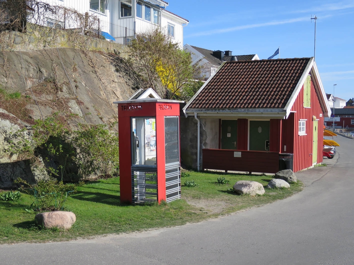 This is the story of how Norway’s most important conversation-space was designed by a young, freshly graduated man from Bergen.

“Norwegian architects are hereby invited…”
In the autumn of 1932, Oslo Telefonanlegginitiated an architectural competition. Finally, Oslo would get its own telephone booth. The city had had so called “talking-stations” from 1885, which in turn were overtaken by automatic telephones 
 only available at selected Narvesen kiosks. The state 
was of the opinion that now was the time to offer the public a better service; public telephone booths open 24/7, like the ones they already had in Sweden and England. But what would they look like, these new telephone booths? What considerations would it
 be necessary to take when designing it? The telegraph board developed a detailed list of demands and restraints: “The booth is intended to be placed outside on the streets and squares and need to be designed so that snow and ice does not hinder the opening and closing of the doors,” they wrote. “To prevent vandalism, theft, uncleanliness etc. inside the booth, it needs to be designed so that from all angles one may see what is going on in there.” Additionally, it would need to withstand storms and bad weather, and “preferably also being whipped by rain mixed with seawater” 

This was not all: The appearance would have to be «pleasing». The booth also needed to be movable, so that it could be taken in to be serviced at Telegrafverket’s main workshops. The reqired material was iron, and the surface was to be spray painted  preferably using car-body paint. There was a requirement for “a writing shelf, a pack shelf, and a suitable place for the telephone catalogue.” Also, there would need to be an illuminated TELEFON  sign, easily visible from all four angles. The total cost for each booth should not exceed 1000 kroner. The first prize for coming up with such a product was 800 kroner.

“Norwegianarchitects are hereby invited to partake in a competition for the design of a telephone booth…”  

The man with the solution
«At some point in 1932, Georg Fredrik sat at a party in Bergen. Maybe he felt a bit lost and forgotten as he often had throughout his life. He retreated to a quiet corner, took out a pencil and strted doodling on a matchbox.  According to my mother, this was how the telephone booth came into being.” In the book “Norges lille røde  historien om telefonkiosken,” Lars Fasting describes his father, the man who is far less known than the iconic architctural structure he left behind. Georg Fredrik Fasting was from Bergen, born into a family of working people and smallholders. One unusual facet of Georg Fredrik was that he was born without ears. His mother made sure he learnt to speak, read and write, 
ut Lars Fasting indicates that his father would seek refuge in drawing when the social challenges became too much to bear. And in the end drawing became his profession. In 1924 he secured a guarantor for a student loan, and started studying to become an a
rchitect at the NTH. Throughout the 1930s he entered several architectural competitions, with drafts produced, according to his son, “after work and in the late hours of the night.”

His efforts were not wasted. Out of 93 entries, with names such as “Flirt”, “Brrr”, “Ring” and “Amor”, the jury selected Fasting’s submission, “RIKS” as the new telephone booth: “The draft shows a strikingly simple solution to the task, technically as well as aesthetically well worked out.”

Taut and provident
Simple and aesthetc are the keywords here. Fasting had designed a booth pointing towards the future, and to modernism. Just how modern it was can be seen by comparing RIKS to the British telephone booth, also designed in the interwar-era. While the British version with it classicistic style is looking back to the heyday of the empire, Fasting’s booth is progressive and functionalistic. Like most Norwegian architects, Fasting broke with the classicistic style of architecture after the Stockholm-exhibition in 1930. “After it, almost all buildings erected in Norway until the German invasion in 1940, were in the functionalistic architectural style,” writes senior curator of architecture at the Norwegian National Museum, Ulf Grønvold, in the book, “Den lille røde”.“TheNorwegian booth is a piece of functionalistic architecture, an asymmetric composition with its roof slab overhanging the word TELEFON, in bold sans seraph lettering,”concludes Ulf Grønvold.

Fashionably red
And it was red. Fasting chose a colour which was part of the modern palette. “A bright red colour, but not as shiny as a signal red, the character of the colour places it among the fashionable colours within functionalism,” states paintings conservator and researcher in NIKU (Norwegian Institute for Cultural Heitage Research), Jon Brænne. In his opinion, Fasting went for visibility without making the booth stand out too much from its surroundings. The original colour was in use up to around 1950, when it changed to signal red. Towards the end of the 1970s the clour was again adjusted towards today’s orangey red.

The design, however, has not changed. RIKS is eighty years and still looks remarkably good. That’s what makes Fasting’s telephone booth a classic  even before it was added to DOCOMOMO’s list over moden icons of design. For Telenor, the telephone booth has served as a pathway into the hearts of the public. For many, Telenor (Televerket) was synonymous with exactly this telephone booth, because this was where one would go to place a call. Having a home
phone was not common until the 1980s. As such the red box became part of the Norwegian everyday and consciousness. The symbol- and publicity value of this is hard to evaluate, but in 2007 it was time to give honour where honour was due, Telenor, in consul
tation with the Directorate for Cultural Heritage, decided to preserve 100 telephone booths for all eternity.

And what about Georg Fredrik Fasting? What happened to him? At the age of 56 an entry in his diary states: «I CAN HEAR». As the first person in th world he had undergone an operation where he had ear canals constructed and eardrums fitted. For the rest of his life, the man behind Norway’s own telephone booth could answer the telephone himself.

Source: Norges lille røde historien om telefonkiosken (2007), issued by The Norwegian Telecom Museum and Telenor Cultural Heritage.