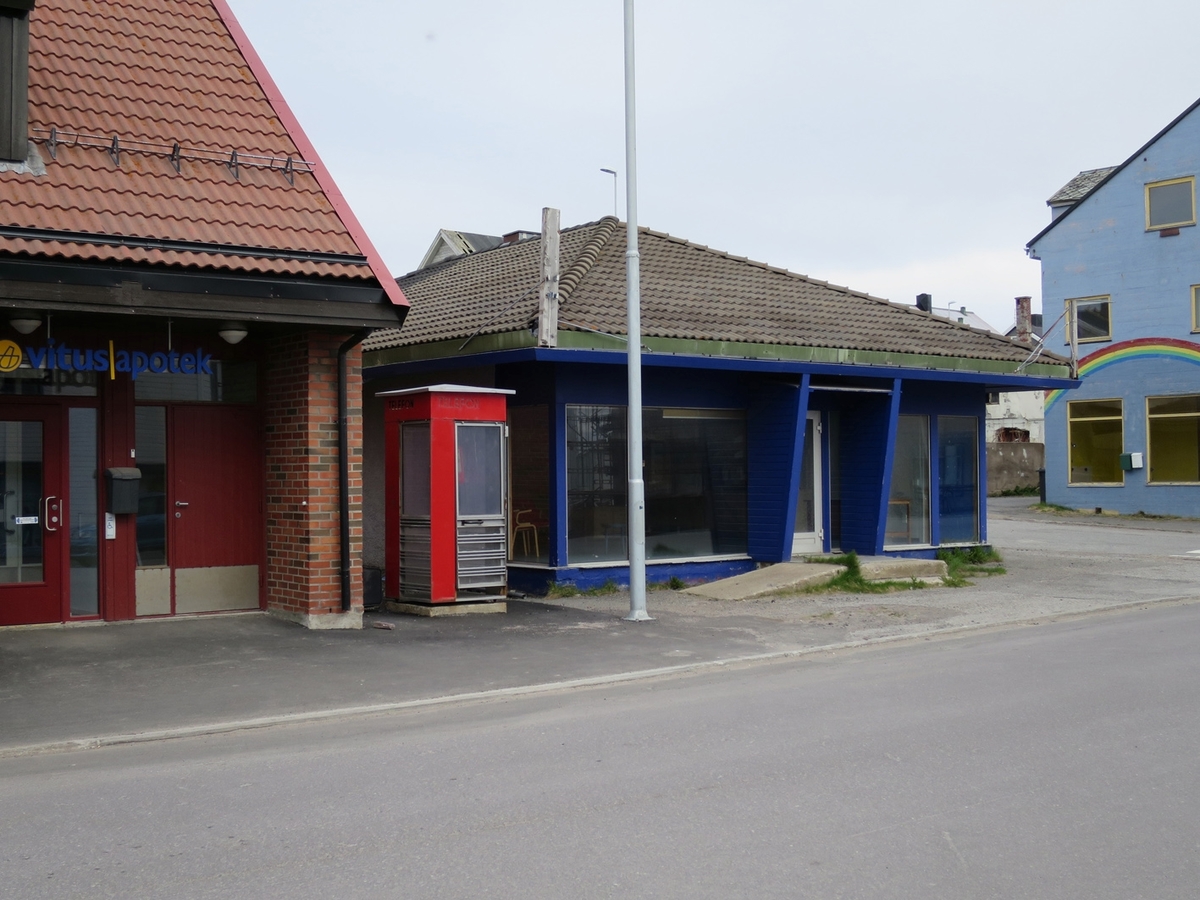 This is the story of how Norway’s most important conversation-space was designed by a young, freshly graduated man from Bergen.

“Norwegian architects are hereby invited…”
In the autumn of 1932, Oslo Telefonanlegginitiated an architectural competition. Finally, Oslo would get its own telephone booth. The city had had so called “talking-stations” from 1885, which in turn were overtaken by automatic telephones 
 only available at selected Narvesen kiosks. The state 
was of the opinion that now was the time to offer the public a better service; public telephone booths open 24/7, like the ones they already had in Sweden and England. But what would they look like, these new telephone booths? What considerations would it
 be necessary to take when designing it? The telegraph board developed a detailed list of demands and restraints: “The booth is intended to be placed outside on the streets and squares and need to be designed so that snow and ice does not hinder the opening and closing of the doors,” they wrote. “To prevent vandalism, theft, uncleanliness etc. inside the booth, it needs to be designed so that from all angles one may see what is going on in there.” Additionally, it would need to withstand storms and bad weather, and “preferably also being whipped by rain mixed with seawater” 

This was not all: The appearance would have to be «pleasing». The booth also needed to be movable, so that it could be taken in to be serviced at Telegrafverket’s main workshops. The reqired material was iron, and the surface was to be spray painted  preferably using car-body paint. There was a requirement for “a writing shelf, a pack shelf, and a suitable place for the telephone catalogue.” Also, there would need to be an illuminated TELEFON  sign, easily visible from all four angles. The total cost for each booth should not exceed 1000 kroner. The first prize for coming up with such a product was 800 kroner.

“Norwegianarchitects are hereby invited to partake in a competition for the design of a telephone booth…”  

The man with the solution
«At some point in 1932, Georg Fredrik sat at a party in Bergen. Maybe he felt a bit lost and forgotten as he often had throughout his life. He retreated to a quiet corner, took out a pencil and strted doodling on a matchbox.  According to my mother, this was how the telephone booth came into being.” In the book “Norges lille røde  historien om telefonkiosken,” Lars Fasting describes his father, the man who is far less known than the iconic architctural structure he left behind. Georg Fredrik Fasting was from Bergen, born into a family of working people and smallholders. One unusual facet of Georg Fredrik was that he was born without ears. His mother made sure he learnt to speak, read and write, 
ut Lars Fasting indicates that his father would seek refuge in drawing when the social challenges became too much to bear. And in the end drawing became his profession. In 1924 he secured a guarantor for a student loan, and started studying to become an a
rchitect at the NTH. Throughout the 1930s he entered several architectural competitions, with drafts produced, according to his son, “after work and in the late hours of the night.”

His efforts were not wasted. Out of 93 entries, with names such as “Flirt”, “Brrr”, “Ring” and “Amor”, the jury selected Fasting’s submission, “RIKS” as the new telephone booth: “The draft shows a strikingly simple solution to the task, technically as well as aesthetically well worked out.”

Taut and provident
Simple and aesthetc are the keywords here. Fasting had designed a booth pointing towards the future, and to modernism. Just how modern it was can be seen by comparing RIKS to the British telephone booth, also designed in the interwar-era. While the British version with it classicistic style is looking back to the heyday of the empire, Fasting’s booth is progressive and functionalistic. Like most Norwegian architects, Fasting broke with the classicistic style of architecture after the Stockholm-exhibition in 1930. “After it, almost all buildings erected in Norway until the German invasion in 1940, were in the functionalistic architectural style,” writes senior curator of architecture at the Norwegian National Museum, Ulf Grønvold, in the book, “Den lille røde”.“TheNorwegian booth is a piece of functionalistic architecture, an asymmetric composition with its roof slab overhanging the word TELEFON, in bold sans seraph lettering,”concludes Ulf Grønvold.

Fashionably red
And it was red. Fasting chose a colour which was part of the modern palette. “A bright red colour, but not as shiny as a signal red, the character of the colour places it among the fashionable colours within functionalism,” states paintings conservator and researcher in NIKU (Norwegian Institute for Cultural Heitage Research), Jon Brænne. In his opinion, Fasting went for visibility without making the booth stand out too much from its surroundings. The original colour was in use up to around 1950, when it changed to signal red. Towards the end of the 1970s the clour was again adjusted towards today’s orangey red.

The design, however, has not changed. RIKS is eighty years and still looks remarkably good. That’s what makes Fasting’s telephone booth a classic  even before it was added to DOCOMOMO’s list over moden icons of design. For Telenor, the telephone booth has served as a pathway into the hearts of the public. For many, Telenor (Televerket) was synonymous with exactly this telephone booth, because this was where one would go to place a call. Having a home
phone was not common until the 1980s. As such the red box became part of the Norwegian everyday and consciousness. The symbol- and publicity value of this is hard to evaluate, but in 2007 it was time to give honour where honour was due, Telenor, in consul
tation with the Directorate for Cultural Heritage, decided to preserve 100 telephone booths for all eternity.

And what about Georg Fredrik Fasting? What happened to him? At the age of 56 an entry in his diary states: «I CAN HEAR». As the first person in th world he had undergone an operation where he had ear canals constructed and eardrums fitted. For the rest of his life, the man behind Norway’s own telephone booth could answer the telephone himself.

Source: Norges lille røde historien om telefonkiosken (2007), issued by The Norwegian Telecom Museum and Telenor Cultural Heritage.