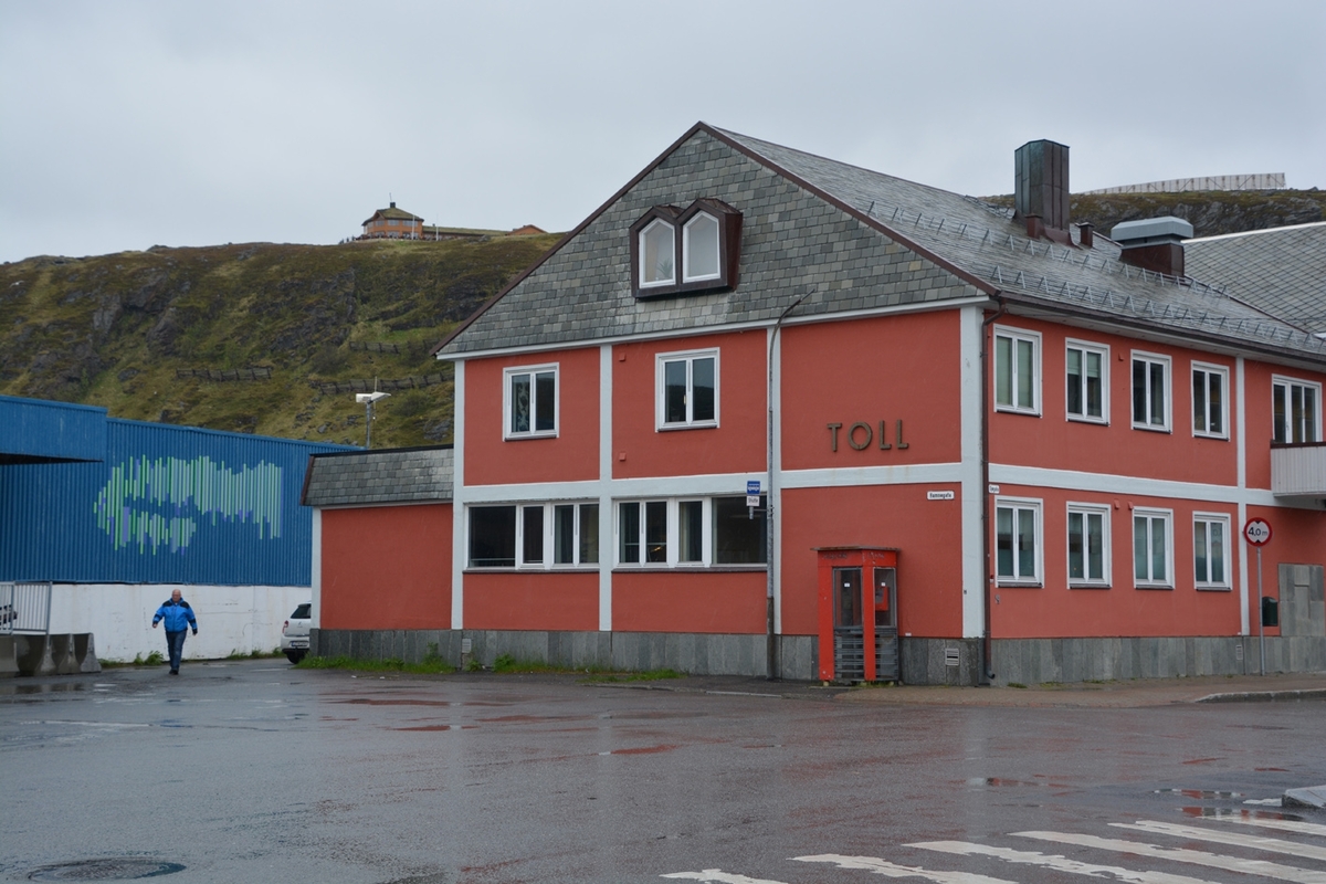 This is the story of how Norway’s most important conversation-space was designed by a young, freshly graduated man from Bergen.

“Norwegian architects are hereby invited…”
In the autumn of 1932, Oslo Telefonanlegginitiated an architectural competition. Finally, Oslo would get its own telephone booth. The city had had so called “talking-stations” from 1885, which in turn were overtaken by automatic telephones 
 only available at selected Narvesen kiosks. The state 
was of the opinion that now was the time to offer the public a better service; public telephone booths open 24/7, like the ones they already had in Sweden and England. But what would they look like, these new telephone booths? What considerations would it
 be necessary to take when designing it? The telegraph board developed a detailed list of demands and restraints: “The booth is intended to be placed outside on the streets and squares and need to be designed so that snow and ice does not hinder the opening and closing of the doors,” they wrote. “To prevent vandalism, theft, uncleanliness etc. inside the booth, it needs to be designed so that from all angles one may see what is going on in there.” Additionally, it would need to withstand storms and bad weather, and “preferably also being whipped by rain mixed with seawater” 

This was not all: The appearance would have to be «pleasing». The booth also needed to be movable, so that it could be taken in to be serviced at Telegrafverket’s main workshops. The reqired material was iron, and the surface was to be spray painted  preferably using car-body paint. There was a requirement for “a writing shelf, a pack shelf, and a suitable place for the telephone catalogue.” Also, there would need to be an illuminated TELEFON  sign, easily visible from all four angles. The total cost for each booth should not exceed 1000 kroner. The first prize for coming up with such a product was 800 kroner.

“Norwegianarchitects are hereby invited to partake in a competition for the design of a telephone booth…”  

The man with the solution
«At some point in 1932, Georg Fredrik sat at a party in Bergen. Maybe he felt a bit lost and forgotten as he often had throughout his life. He retreated to a quiet corner, took out a pencil and strted doodling on a matchbox.  According to my mother, this was how the telephone booth came into being.” In the book “Norges lille røde  historien om telefonkiosken,” Lars Fasting describes his father, the man who is far less known than the iconic architctural structure he left behind. Georg Fredrik Fasting was from Bergen, born into a family of working people and smallholders. One unusual facet of Georg Fredrik was that he was born without ears. His mother made sure he learnt to speak, read and write, 
ut Lars Fasting indicates that his father would seek refuge in drawing when the social challenges became too much to bear. And in the end drawing became his profession. In 1924 he secured a guarantor for a student loan, and started studying to become an a
rchitect at the NTH. Throughout the 1930s he entered several architectural competitions, with drafts produced, according to his son, “after work and in the late hours of the night.”

His efforts were not wasted. Out of 93 entries, with names such as “Flirt”, “Brrr”, “Ring” and “Amor”, the jury selected Fasting’s submission, “RIKS” as the new telephone booth: “The draft shows a strikingly simple solution to the task, technically as well as aesthetically well worked out.”

Taut and provident
Simple and aesthetc are the keywords here. Fasting had designed a booth pointing towards the future, and to modernism. Just how modern it was can be seen by comparing RIKS to the British telephone booth, also designed in the interwar-era. While the British version with it classicistic style is looking back to the heyday of the empire, Fasting’s booth is progressive and functionalistic. Like most Norwegian architects, Fasting broke with the classicistic style of architecture after the Stockholm-exhibition in 1930. “After it, almost all buildings erected in Norway until the German invasion in 1940, were in the functionalistic architectural style,” writes senior curator of architecture at the Norwegian National Museum, Ulf Grønvold, in the book, “Den lille røde”.“TheNorwegian booth is a piece of functionalistic architecture, an asymmetric composition with its roof slab overhanging the word TELEFON, in bold sans seraph lettering,”concludes Ulf Grønvold.

Fashionably red
And it was red. Fasting chose a colour which was part of the modern palette. “A bright red colour, but not as shiny as a signal red, the character of the colour places it among the fashionable colours within functionalism,” states paintings conservator and researcher in NIKU (Norwegian Institute for Cultural Heitage Research), Jon Brænne. In his opinion, Fasting went for visibility without making the booth stand out too much from its surroundings. The original colour was in use up to around 1950, when it changed to signal red. Towards the end of the 1970s the clour was again adjusted towards today’s orangey red.

The design, however, has not changed. RIKS is eighty years and still looks remarkably good. That’s what makes Fasting’s telephone booth a classic  even before it was added to DOCOMOMO’s list over moden icons of design. For Telenor, the telephone booth has served as a pathway into the hearts of the public. For many, Telenor (Televerket) was synonymous with exactly this telephone booth, because this was where one would go to place a call. Having a home
phone was not common until the 1980s. As such the red box became part of the Norwegian everyday and consciousness. The symbol- and publicity value of this is hard to evaluate, but in 2007 it was time to give honour where honour was due, Telenor, in consul
tation with the Directorate for Cultural Heritage, decided to preserve 100 telephone booths for all eternity.

And what about Georg Fredrik Fasting? What happened to him? At the age of 56 an entry in his diary states: «I CAN HEAR». As the first person in th world he had undergone an operation where he had ear canals constructed and eardrums fitted. For the rest of his life, the man behind Norway’s own telephone booth could answer the telephone himself.

Source: Norges lille røde historien om telefonkiosken (2007), issued by The Norwegian Telecom Museum and Telenor Cultural Heritage.