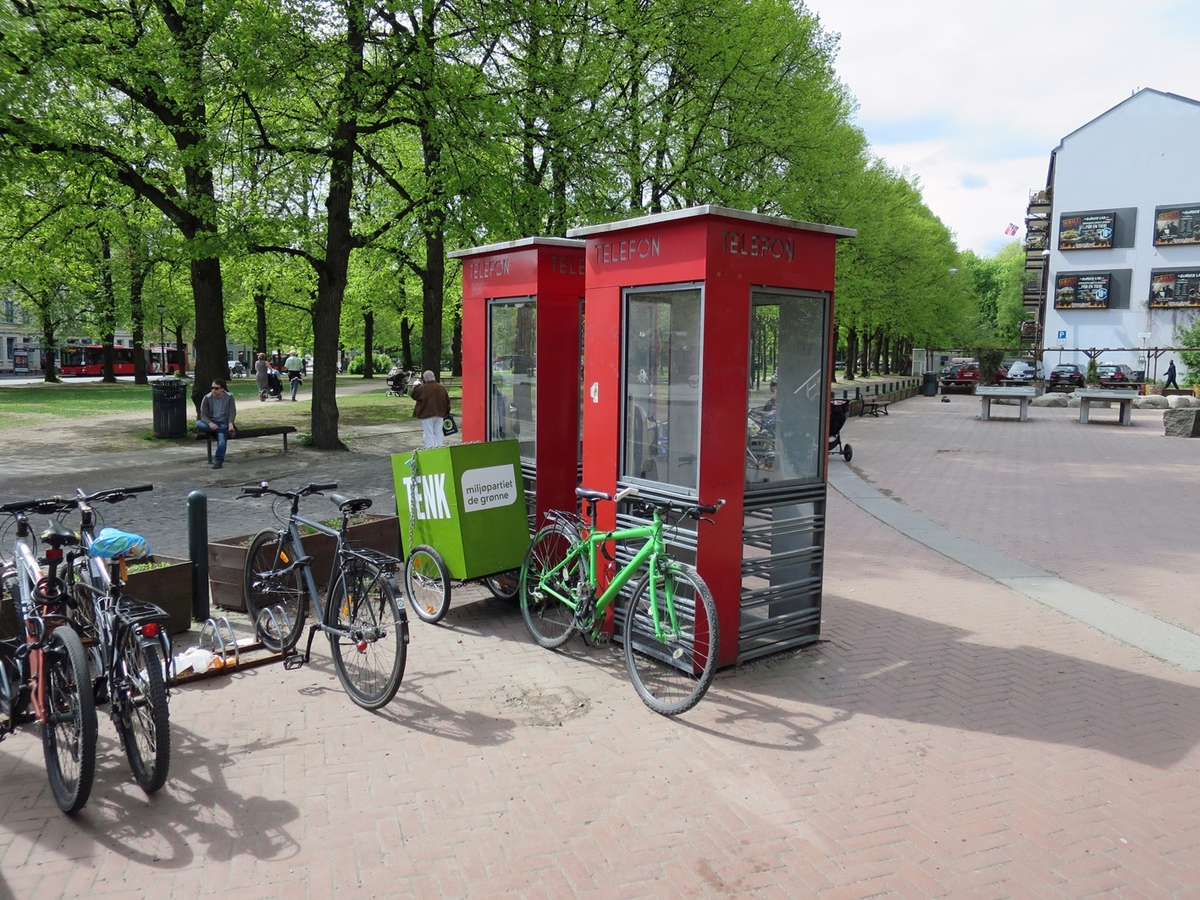 This is the story of how Norway’s most important conversation-space was designed by a young, freshly graduated man from Bergen.

“Norwegian architects are hereby invited…”
In the autumn of 1932, Oslo Telefonanlegginitiated an architectural competition. Finally, Oslo would get its own telephone booth. The city had had so called “talking-stations” from 1885, which in turn were overtaken by automatic telephones 
 only available at selected Narvesen kiosks. The state 
was of the opinion that now was the time to offer the public a better service; public telephone booths open 24/7, like the ones they already had in Sweden and England. But what would they look like, these new telephone booths? What considerations would it
 be necessary to take when designing it? The telegraph board developed a detailed list of demands and restraints: “The booth is intended to be placed outside on the streets and squares and need to be designed so that snow and ice does not hinder the opening and closing of the doors,” they wrote. “To prevent vandalism, theft, uncleanliness etc. inside the booth, it needs to be designed so that from all angles one may see what is going on in there.” Additionally, it would need to withstand storms and bad weather, and “preferably also being whipped by rain mixed with seawater” 

This was not all: The appearance would have to be «pleasing». The booth also needed to be movable, so that it could be taken in to be serviced at Telegrafverket’s main workshops. The reqired material was iron, and the surface was to be spray painted  preferably using car-body paint. There was a requirement for “a writing shelf, a pack shelf, and a suitable place for the telephone catalogue.” Also, there would need to be an illuminated TELEFON  sign, easily visible from all four angles. The total cost for each booth should not exceed 1000 kroner. The first prize for coming up with such a product was 800 kroner.

“Norwegianarchitects are hereby invited to partake in a competition for the design of a telephone booth…”  

The man with the solution
«At some point in 1932, Georg Fredrik sat at a party in Bergen. Maybe he felt a bit lost and forgotten as he often had throughout his life. He retreated to a quiet corner, took out a pencil and strted doodling on a matchbox.  According to my mother, this was how the telephone booth came into being.” In the book “Norges lille røde  historien om telefonkiosken,” Lars Fasting describes his father, the man who is far less known than the iconic architctural structure he left behind. Georg Fredrik Fasting was from Bergen, born into a family of working people and smallholders. One unusual facet of Georg Fredrik was that he was born without ears. His mother made sure he learnt to speak, read and write, 
ut Lars Fasting indicates that his father would seek refuge in drawing when the social challenges became too much to bear. And in the end drawing became his profession. In 1924 he secured a guarantor for a student loan, and started studying to become an a
rchitect at the NTH. Throughout the 1930s he entered several architectural competitions, with drafts produced, according to his son, “after work and in the late hours of the night.”

His efforts were not wasted. Out of 93 entries, with names such as “Flirt”, “Brrr”, “Ring” and “Amor”, the jury selected Fasting’s submission, “RIKS” as the new telephone booth: “The draft shows a strikingly simple solution to the task, technically as well as aesthetically well worked out.”

Taut and provident
Simple and aesthetc are the keywords here. Fasting had designed a booth pointing towards the future, and to modernism. Just how modern it was can be seen by comparing RIKS to the British telephone booth, also designed in the interwar-era. While the British version with it classicistic style is looking back to the heyday of the empire, Fasting’s booth is progressive and functionalistic. Like most Norwegian architects, Fasting broke with the classicistic style of architecture after the Stockholm-exhibition in 1930. “After it, almost all buildings erected in Norway until the German invasion in 1940, were in the functionalistic architectural style,” writes senior curator of architecture at the Norwegian National Museum, Ulf Grønvold, in the book, “Den lille røde”.“TheNorwegian booth is a piece of functionalistic architecture, an asymmetric composition with its roof slab overhanging the word TELEFON, in bold sans seraph lettering,”concludes Ulf Grønvold.

Fashionably red
And it was red. Fasting chose a colour which was part of the modern palette. “A bright red colour, but not as shiny as a signal red, the character of the colour places it among the fashionable colours within functionalism,” states paintings conservator and researcher in NIKU (Norwegian Institute for Cultural Heitage Research), Jon Brænne. In his opinion, Fasting went for visibility without making the booth stand out too much from its surroundings. The original colour was in use up to around 1950, when it changed to signal red. Towards the end of the 1970s the clour was again adjusted towards today’s orangey red.

The design, however, has not changed. RIKS is eighty years and still looks remarkably good. That’s what makes Fasting’s telephone booth a classic  even before it was added to DOCOMOMO’s list over moden icons of design. For Telenor, the telephone booth has served as a pathway into the hearts of the public. For many, Telenor (Televerket) was synonymous with exactly this telephone booth, because this was where one would go to place a call. Having a home
phone was not common until the 1980s. As such the red box became part of the Norwegian everyday and consciousness. The symbol- and publicity value of this is hard to evaluate, but in 2007 it was time to give honour where honour was due, Telenor, in consul
tation with the Directorate for Cultural Heritage, decided to preserve 100 telephone booths for all eternity.

And what about Georg Fredrik Fasting? What happened to him? At the age of 56 an entry in his diary states: «I CAN HEAR». As the first person in th world he had undergone an operation where he had ear canals constructed and eardrums fitted. For the rest of his life, the man behind Norway’s own telephone booth could answer the telephone himself.

Source: Norges lille røde historien om telefonkiosken (2007), issued by The Norwegian Telecom Museum and Telenor Cultural Heritage.