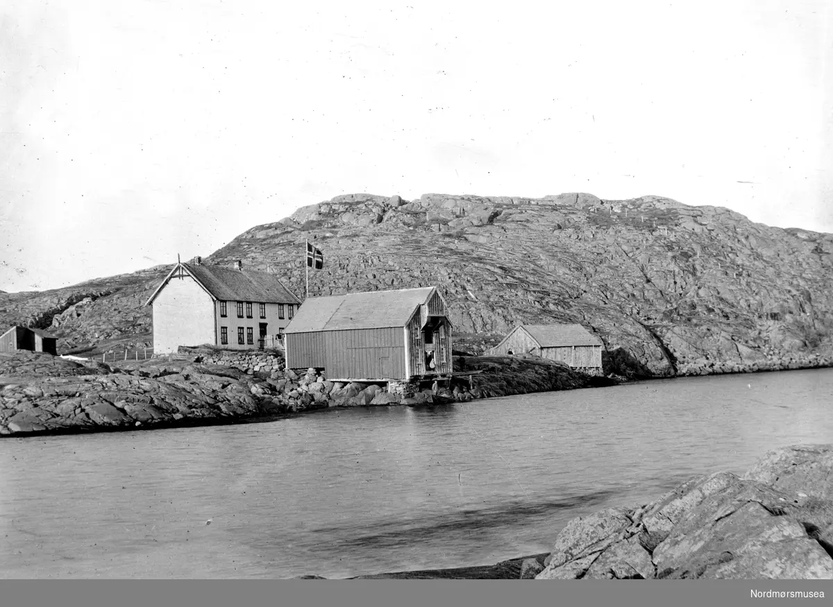 Foto muligens fra Smøla kommune i Møre og Romsdal, hvor vi ser et naust og bolighus nær vannet. Fra Nordmøre museums fotosamlinger. Tilleggsinfo: Kan vera Skartnes med brygge. I dag er det Per Bastian Kuløy som er eigar. Tilleggsinfo: Karle Gjernes sin antakelse bekreftes herved. Dette er Skarpnes gård. (Informant: Per Anton Brennskag.)

 
 
 
 

 I brygga var det i si tid handel/butikk. (Informant: Karle Gjernes.)



