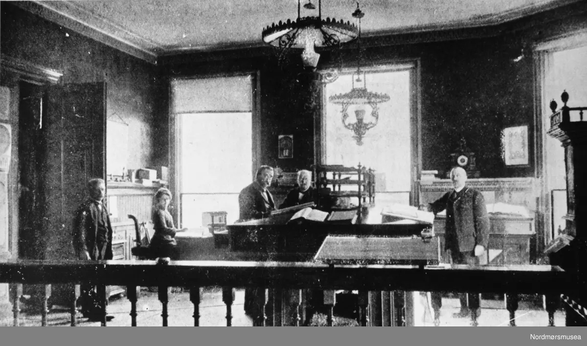 Interiørbilde fra Sparebankens gård i Kristiansund kommune, som ble oppført i 1882. Ukjent datering, men trolig mellom 1890 og 1900. Fra Nordmøre Museums fotosamlinger. Reg: EFR
