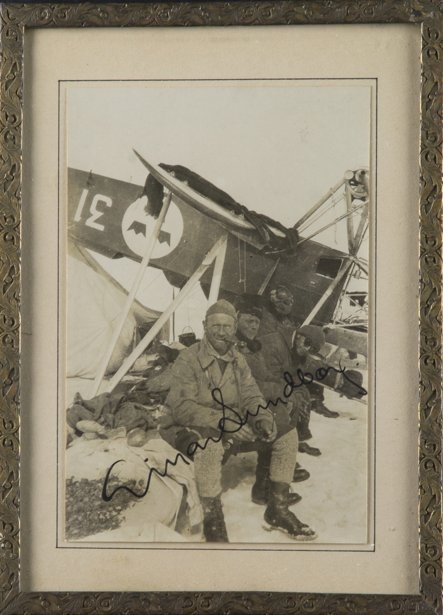 Signerat porträttfotografi av Einar Lundborg och annan besättning strandsatta på isen vid havererat flygplan S 6 Fokker vid Spetsbergsexpeditionen 1928.