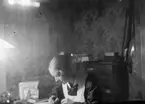Sigrid vid skrivbordet. Tidsomfånget är 1900 - 1940