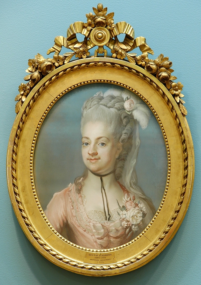 Porträtt, pastell, av grevinnan Juliana Duvall (1759-1789), gift med greve Fredrik Adolf Ulrik Cronstedt. Målat av Gustaf Lundberg. Bröstbild face vänster. Rosa klänning med blommor i dekolletaget. Blå bakgrund.
Montering/Ram: Originalram med originalförgyllning. Överstycke av rosett och blomstergirland. Pendang till G.M. 15707.