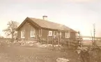Kylbergs stuga. Här hölls småskola 1882, i det stora rummet. Stugan rymmer två rum och ett kök. Tegeltaket tillkom på 1880-talet.