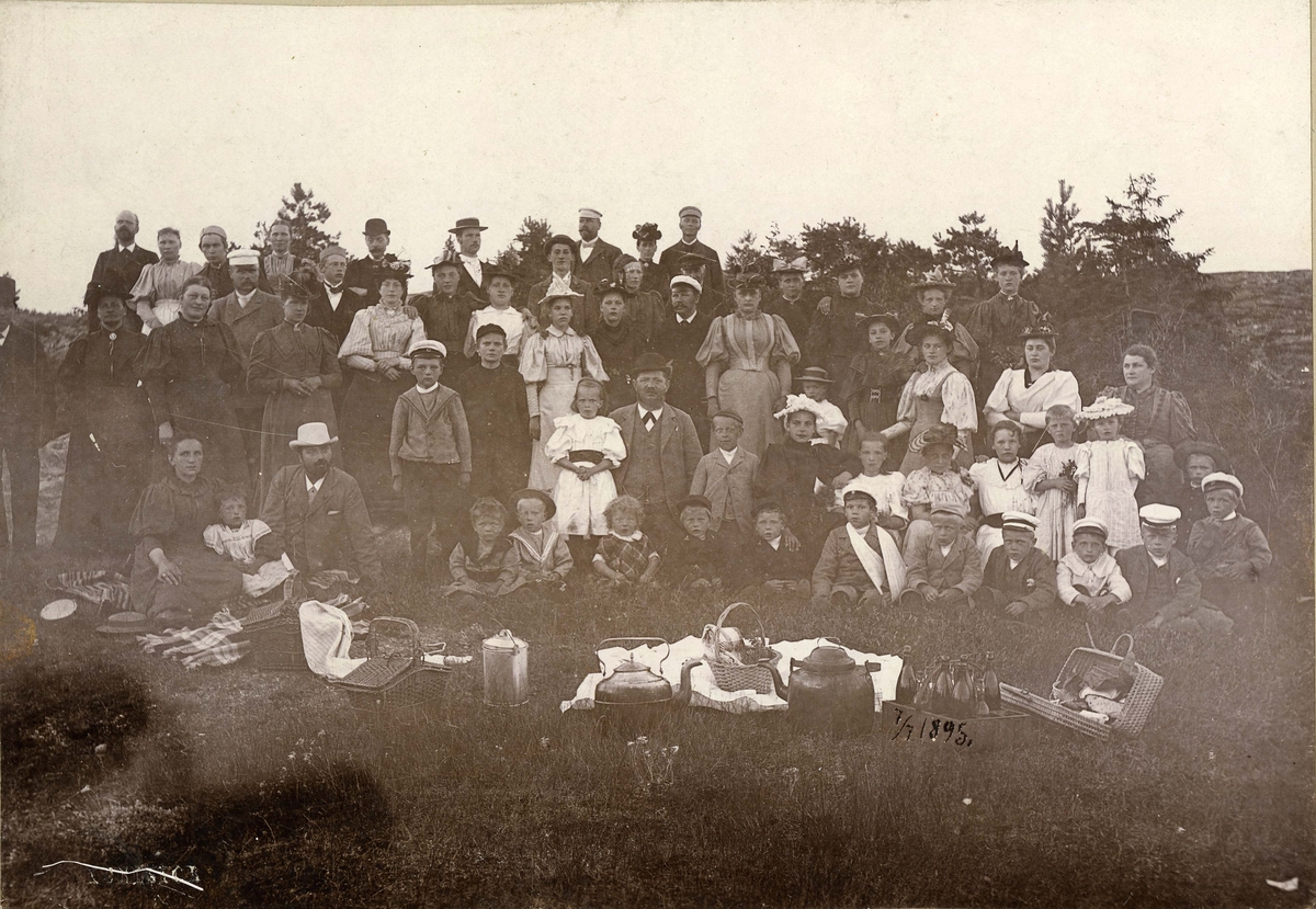 Piknik. Utflukt. Bildet tatt 3. juli 1895. Første rekke nedenfra (fv): Fru pølsemaker Halvorsen, Sigrid Halvorsen, fotpgraf Gerold, Fredrik Halvorsen, Paul Andreassen, Einar Rudstrøm, Philip Resberg, Freddy Resberg, Georg Selenius, Trygve Thorstensen, Holger Brynhildsen, Krogh, Birger Brynildsen, Sverre Halvorsen,  Annen rekke (fv): Oscar Halvorsen, Harald Gerold, ?, J. A. Rudstrøm, Thorstensen, Hilma Resberg, ?, ?, Signe Selenius, Tonny Rudstrøm. - Tredje rekke (fv): ?, ?, Fru Rudstrøm, fru Brynildsen, fru Louisa Resberg, fru Munch, Ebba Munch, Agnes Andreassen, ?, Frk. Schirmer. - 4. rekke (f.v.); H. P. Brynildsen, Ø. Schirmer, ?. Johs. Andreassen, fru Georg Pedersen, ?, ?, Fru Tørresen (født Thorstensen). - 5. rekke (fv): Even Olsen, Karoline Olsen, Schirmer, Julie Næs, Johs. Næs, Georg Pedersen, N. F. Resberg, fru Syver Andreassen, Syver Andreassaen. - Foto: Gerold.