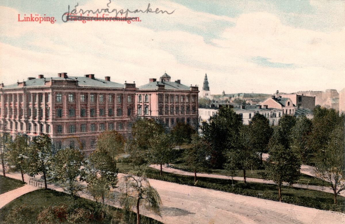 Orig. text: Linköping. Järnvägsparken.
Vy över järnvägsparken och Överstehuset. Järnvägsgatan i förgrunden. Byggmästare J A Johansson uppförde byggnaderna. Arkitekt: Janne Lundin, som även gjorde arbets- och detaljritningarna. Husen är typsiska för 1880-talet. Fasaden ser ut som om det är av sten men är av puts. 
Huset till vänster är Överstehuset med adress Repslagaregatan 1/Järnvägsgatan 8. Uppfört i nyrenässansstil 1889-90.  Huset fick sitt namn då översterna Gadd resp. Reuterswärd hade sina ståndsmässiga lägenheter i huset. 
Det högra huset, Repslagaregatan 3, år 1886-88. Ursprungligen fanns det två lägenheter på varje plan, dvs 8 i hela huset. På 1930-talet delades de upp så att huset innehåll 15 lägenheter. Några lägenheter har på senare tid slagits samman igen.