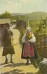 Vykort med man och kvinna iförda folkdräkter från Leksand.