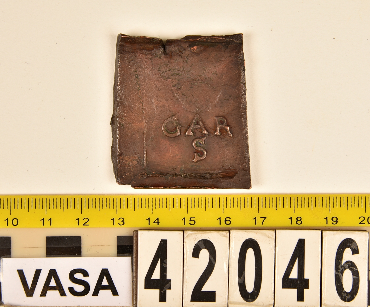 Ett fyrkantigt kopparmynt, s k klipping, med valören 2 öre.

På myntets åtsida syns versalerna G A R, placerade vågrätt mitt på myntet. Ovanför A:et är en krona svagt synlig. Under A:et syns versalen S. Åtsidans ram är delvis synlig. Präglingen är ocentrerad.
På myntets frånsida är en vasakärve svagt synlig. Till vänster om kärvens bas syns siffran två, i form av ett Z. Till höger om kärvens bas är versalerna ÖR delvis synliga. Längst ner på myntet står myntets präglingsår, 1626. Frånsidans ram är delvis synlig. Präglingen är ocentrerad.
Myntets vikt uppgår till 48,8 gram.
Myntets åtsida är krackelerad.

Text in English: Square-shaped coin. Denomination: 2 öre.
The obverse side has the initials G A R spaced horizontally in a row on the coin.  Above the initial A is a crown faintly  visible. Beneath the initial A is the initial S.
The coin stamp is off-centre. The frame is partly visible.
The reverse side has in the centre a Vasa sheaf, faintly legible. To the left of the sheaf is the numeral 2, shaped as a Z. To the right of the sheaf are the initials ÖR partly  visible.
The four digit year of coinage, 1626, is placed beneath the sheaf.
The coin stamp is off-centre. The frame is partly visible.
Present condition: the obverse side has a craquelure-like surface.
Weight: 48,8 gram.