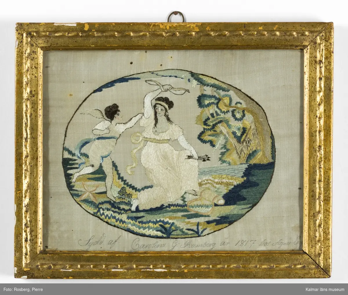 Landskap med figurscen, Amor och Psyke. Psyke har tagit Amors pilar och pilbåge, Amor till vänster i motivet.