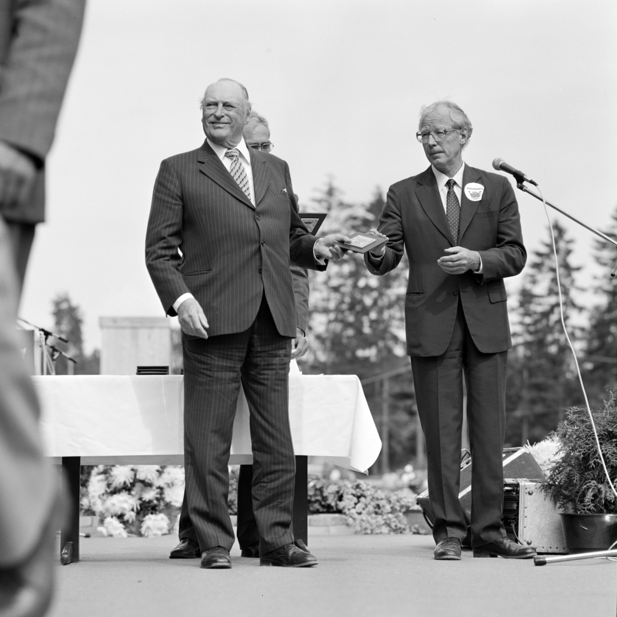 Norske Melkeprodusenters Landsforbund, NML 100 år 1881-1981.
Jubileumsdager, festforestilling, Domkirkeodden, Hamar. Utdeling av plakett til melkeprodusenter, kong Olav V, t..h. adm. direktør i NML Petter Slagsvold.