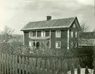 Mangårdsbyggnad på en gård vid stora landsvägen, nära avtagsvägen till kyrkan. 
Ordförandens hus, förr Oskar Karlssons. Byggt av hans far, gamle byggmästaren.