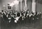 100-årsfesten för sällskapet ÅM 1937. Vid främsta bordet från vänster: 1. Grosshandlare Einar Thernström, 2. Advokat Ragnar Allmér, 3. Bankkamrer E Blomgren, 4. Handelsbiträde Sture Sandahl, 5. Bankkamrer E Blomgren, 6. Kontorist Rune Widjer, 7. Kontorist Witte, 8. Bankdirektör A Sundquist, 9. Disponent E Slettengren, 10. Grosshandlare V Fransson, 11. Kamrer  E Westerlund, 12. Grosshandlare V E Hagman, 13. Tandläkare E Willius, 14. Direktör H Bergvall.