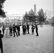 Skridskoåkning och hockespel på Kristinaplan i Gävle, 1957.