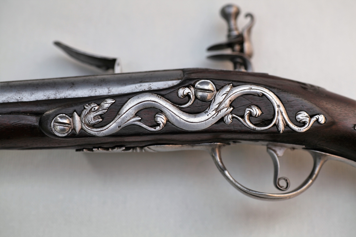 I hanen sitter et stykke flint. Pistolen er i god stand. Den er lik pistol TM-00969.