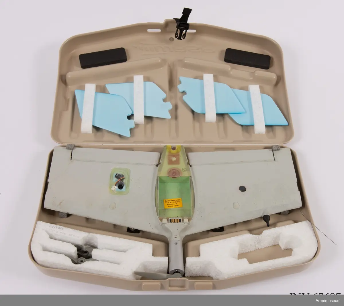 Transportlåda och farkost. Ryggsäck och markkontroll saknas. 
Den obemannade spaningsfarkosten UAV04 Svalan sänder live-video och lokaliseringsinformation till marksändaren. Det ger operatörerna möjlighet att navigera, leta upp mål, rekognoscera i omkringliggande terräng och även att spela in all information för senare analys. Systemet ger stöd i följande områden:
•	Fjärrstyrd rekognoscering och övervakning
•	Truppskydd
•	Konvojsäkerhet
•	Information om målet
•	Uppskattning/värdering av mål förstörda i strid
UAV04 drivs med batteri och har låg visuell, akustisk och termisk signatur. Optiken inkluderar två integrereade Elektro-optiska (EO) färgkameror (för framåt- och sidovinkel) samt en utbytbar nyttolast med antingen framåt- och sidovinkel och zoom EO färgkameror för dagsljusoperationer, och en infraröd (IR) kamera för nattoperationer. 
Hela systemet kan lätt packas ned och upp ur en tillhörande ryggsäck som underlättar både förvaring och transport till otillgängliga platser. Det har främst använts i utprovningssyfte för inköp av ny materiel. 
Elektrisk motor. Manuell eller automatisk glidlandning kan utföras. Flygkapaciteten uppgår till 45 minuter och räckvidden är maximalt 5 km. Maxhastighet: 70 km/h. Vikt: 450 gram. Längd: 240 mm. Spännvidd mellan vingar: 730 mm. Normal operativ höjd: 50-150 meter. Maximal operativ höjd: 3 000 meter. Svängprestanda: 360 grader på 20 sekunder. Navigationsljus (grön/röd) på/av under flygning. GPS (C-code).

Farkosten har levererats utan nattkamera och utan batterier på grund av återanvändning av delmaterielen. De levererade förnödenheterna består av:
F9889-000031 Väska
F9889-000001 Skrov
F9889-000029 Motor
F9889-000028 Propeller (6 st)
F9889-000030 Propeller hub
F9889-000011 Vingspets H
F9889-000023 Vingspets V
F9889-000027 Fena (4 st)
F9889-000002 Kameraenhet dag