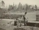 Man i arbete med hammare och städ.
Finnvikskabeln. Borrvässning. Ur albumet Kabelarbetet Hjälmsälra (Hjälmsättra) - Norrtälje -  Finnviken utfört under sommaren 1928.