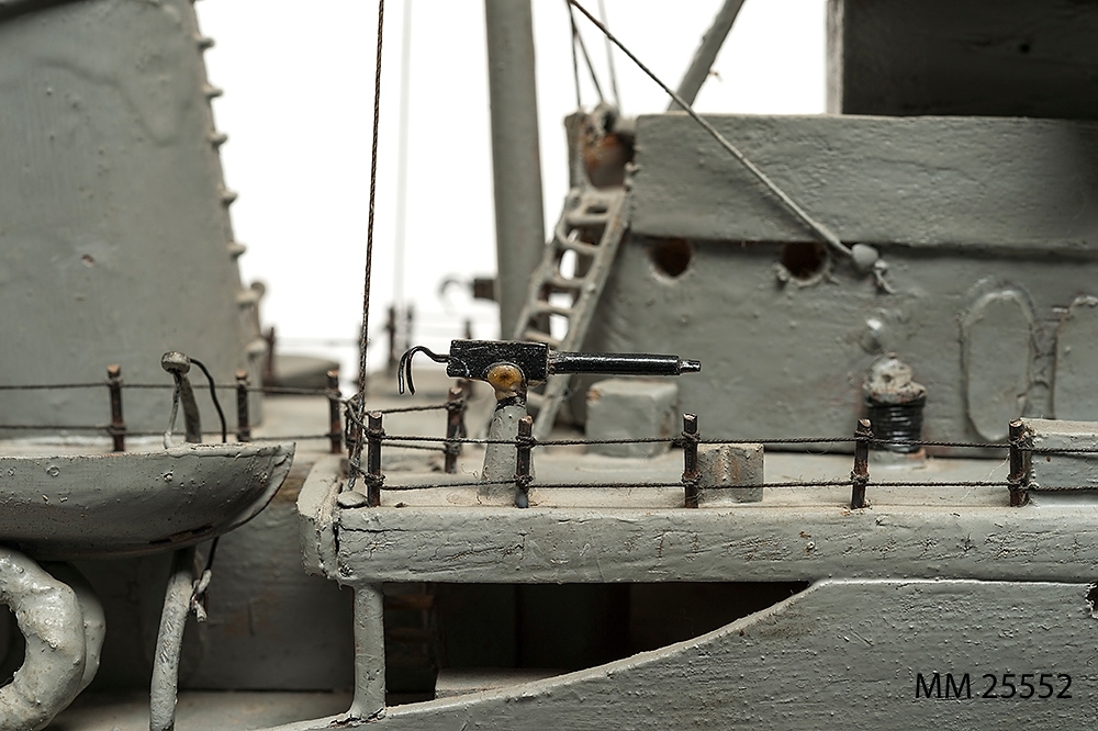 Tämligen grovt tillverkad fartygsmodell, huvudsaklingen gjord av trä. Fartyget är jagaren Mode som är målad grå över vattenlinjen och med röd bottenfärg. Klassiskt jagarskrov med upphöjd back. På fördäck står en kanon i öppen lavett och på akterdäck två likadana pjäser. Två luftvärnspjäser på en upphöjd brygga. En skorsten med svart topp. Slingekölar på båda sidor i rött. På bogen är siffrorna 29 målade. Alldeles för om bryggan och akter om den aktra pjäsen finns vita neutralitetsband målar över däck och ner längs skrovets sida till den svarta vattenlinjen. Fartyget har två propellrar. Bryggan är öppen. Modellen står på en fernissad platta av mörkt trä med hjälp av två profilerade små "pelare".