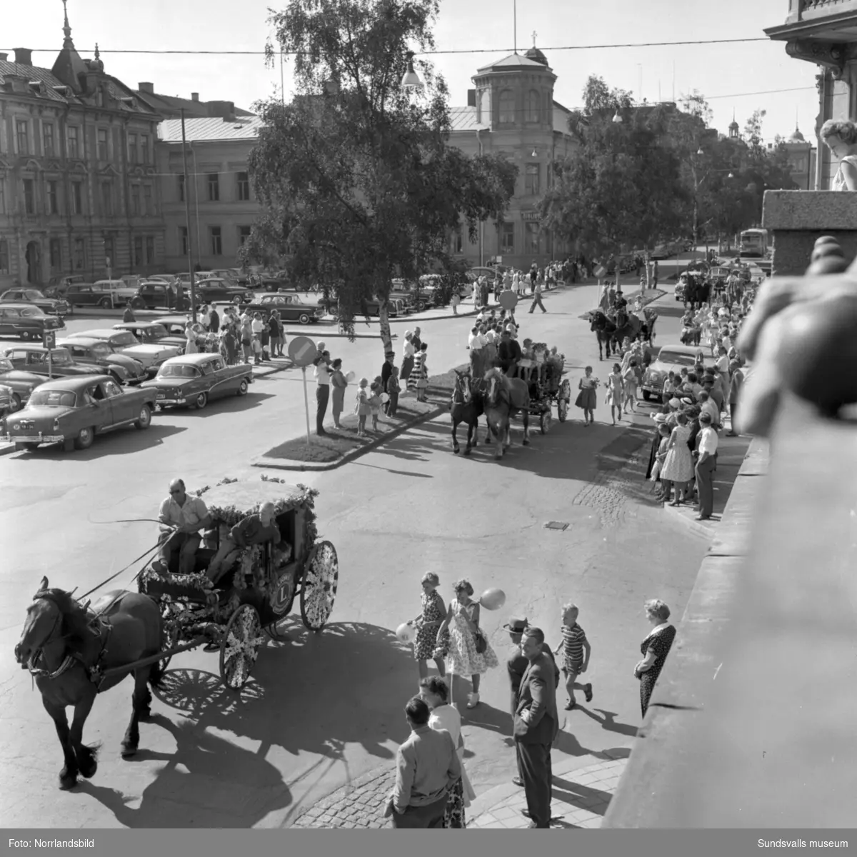 Lions blomstertåg till förmån för CP-skadade barn. Parad med blomsterprydda hästdragna vagnar passerar på Köpmangatan vid Nytorget.