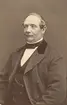 Porträtt av handskmakare Carl Johan Blohm, Linköping. Han drev länge sin verkstad från stadens S:t Kors kvarter 27. År 1875 lämnade han över rörelsen till sin son och flyttade med sin hustru till Tannefors kvarter 3. Från 1846 var han gift med Dorotea Wilhelmina Bredendich, född i Skeda 1828. Han blev änkling 1881 och avled själv året därpå.