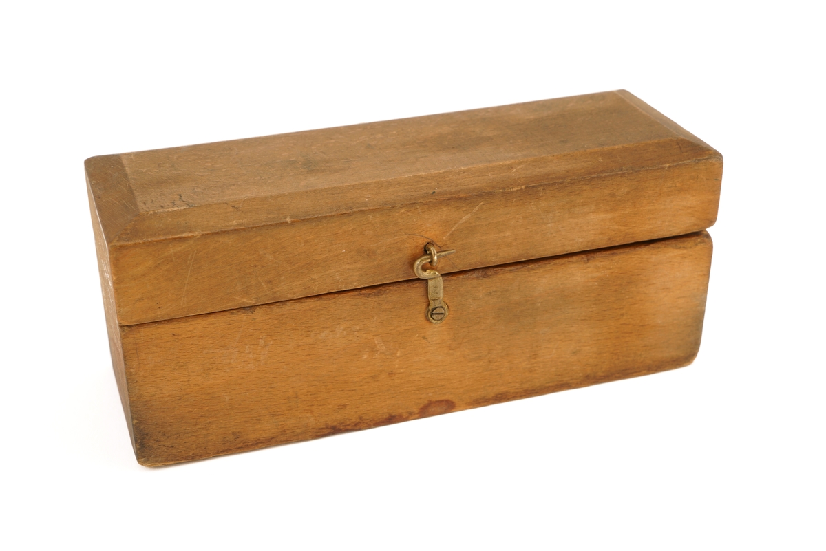 Trekassett inneholdende 10 stk. lodd. Loddene angitt i kg og g.
Loddsamlingen inni er ikke komplett. Seks av loddene er antagelig originale. Fire av loddene har antagelig ikke opprinnelig tilhørt denne esken da de har et annet utseende/annen utforming.