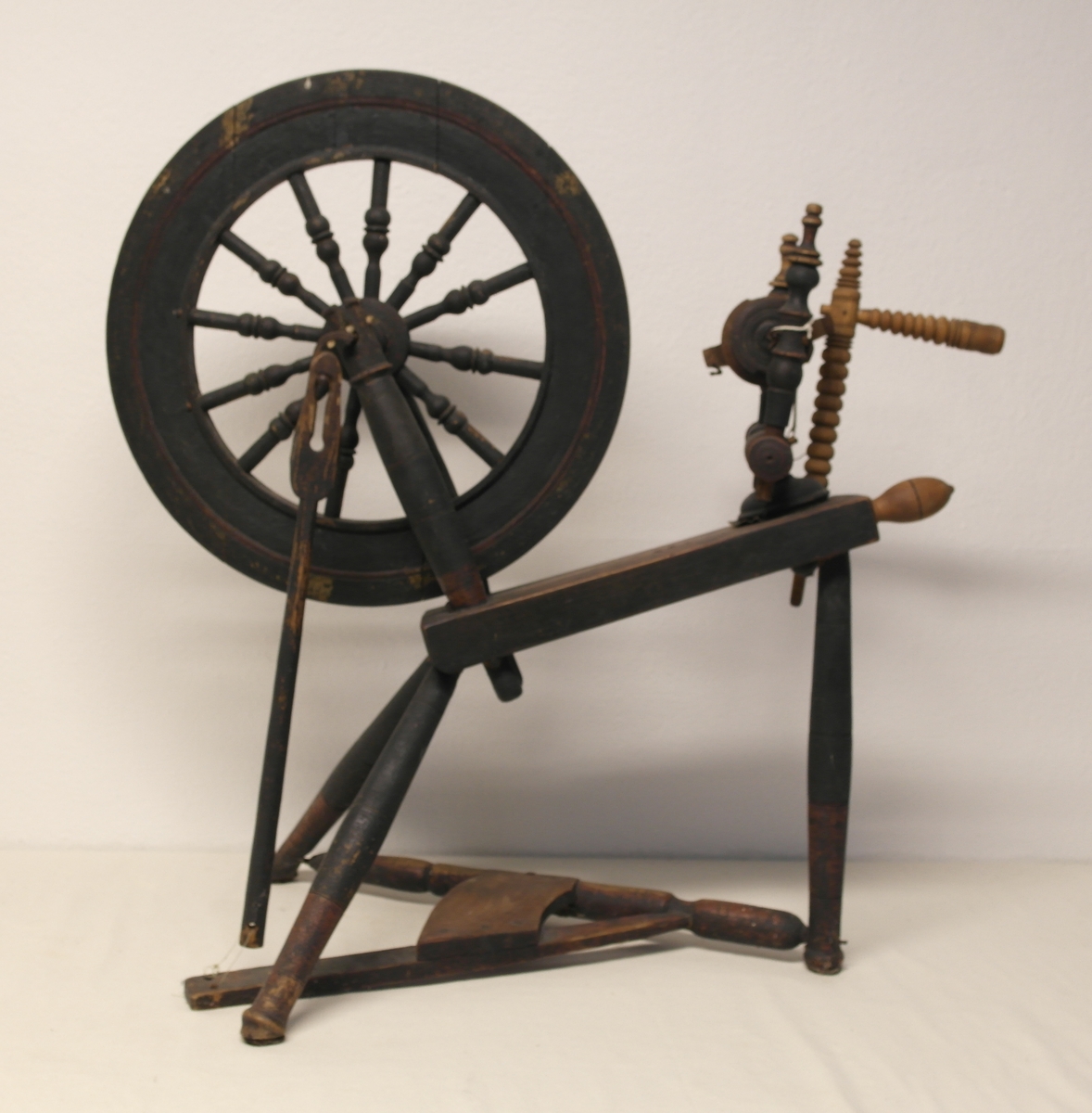 Vingerokk i dreiet, pusset og malt eik. Rokken har pedaldrevet svinghjul og skrått rokkbryst. Fem jernkroker på vingen/spindelen. Spindelen har opprinnelig vært festet med lærhemper i hver side. Rester av rød og svart maling.