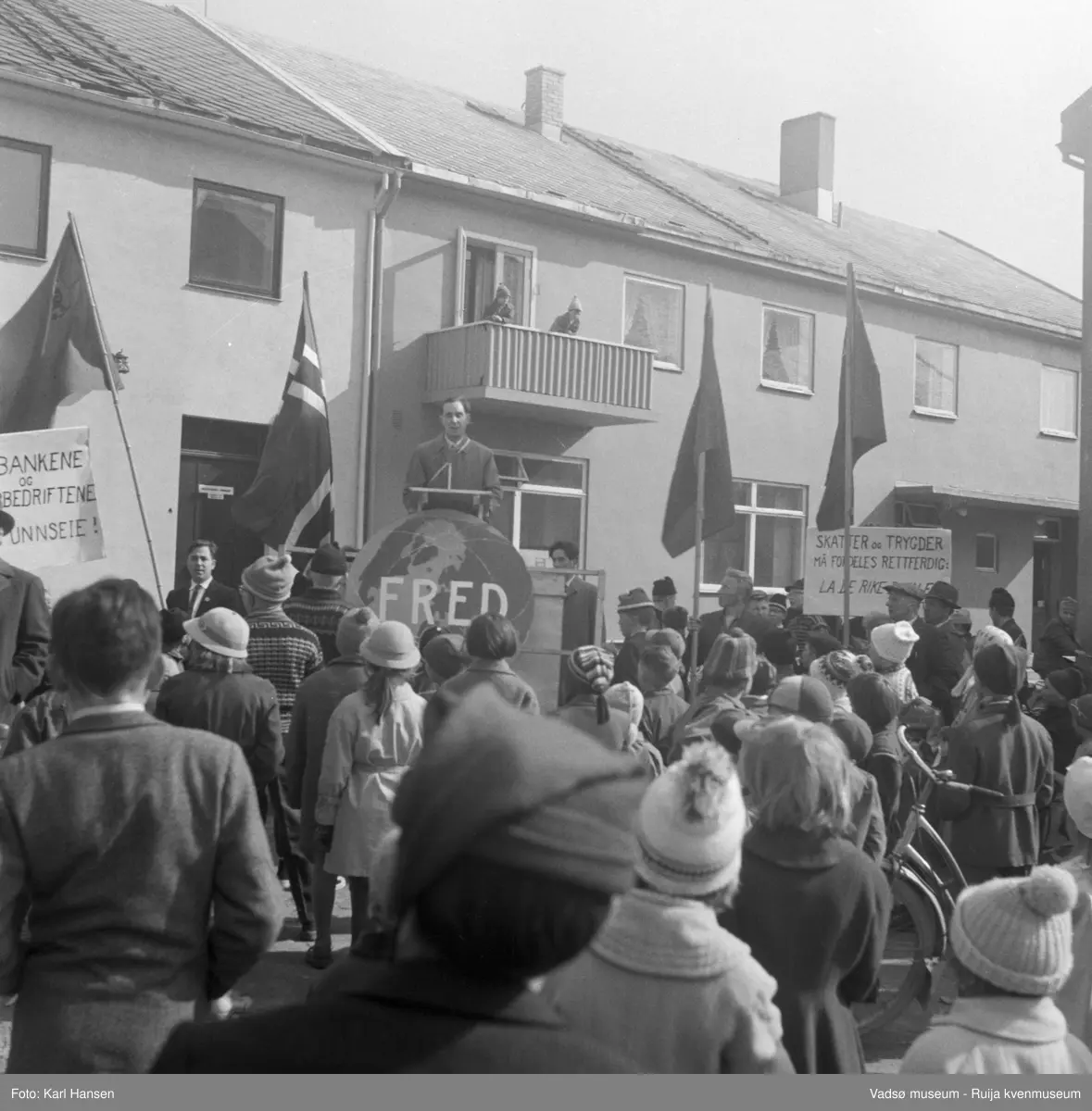 Vadsø 1.mai 1960. Samling og tale på Torget. Bygningen bak taleren er Henriksens bakeri,
