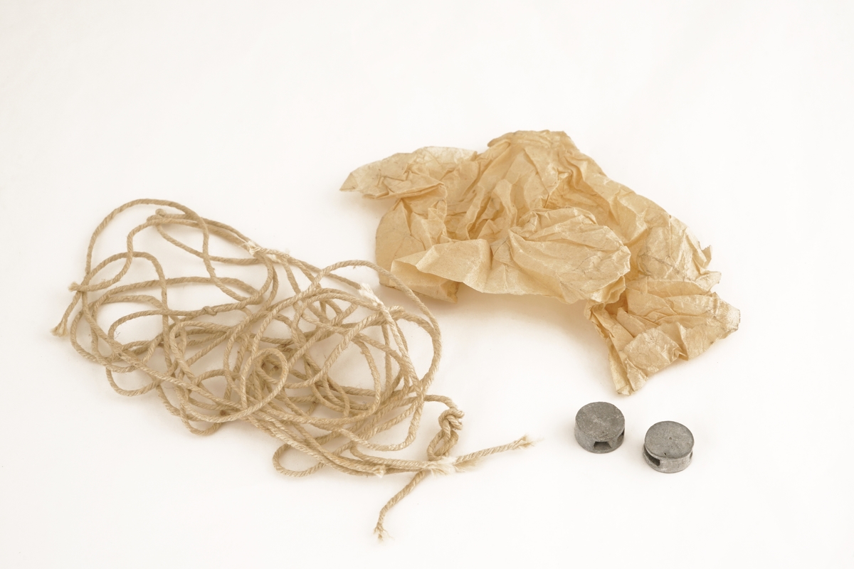 Veske av sort lær foret med tekstil/lerret, og med pappforsterket låsbart lokk . Låsedelen på lokk og veske er av metall. Nøkkel er borte. Vesken inneholder formentlig rester av plomberingstråd og to blyplomber. De smale hyssingen er antakelig brukt som forseglingstråd i tiden før forseglingstråden ble flerfarget. Medfølgende sammenkrøllede papir er antakelig brukt for å omslutte blyplomber.