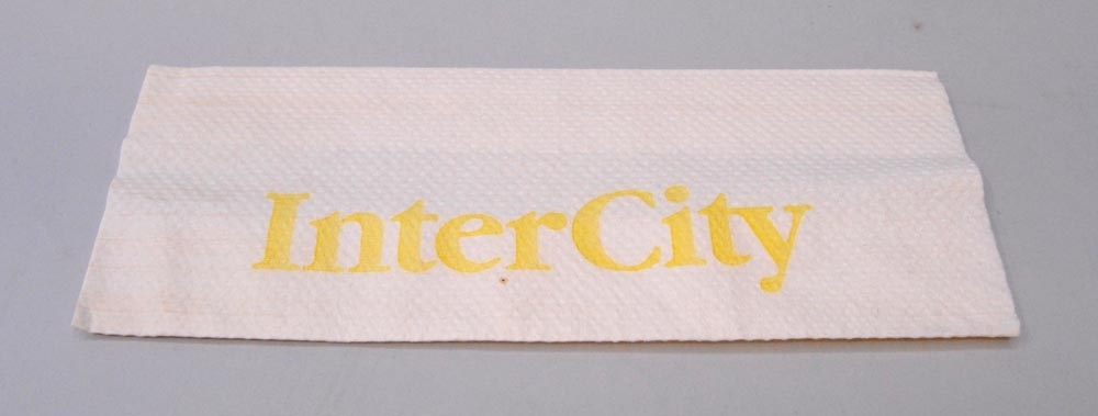 Vitt papper med tryck av gul text på ena sidan "InterCity" och på andra sidan "Katrin Holmen Hygien Mariestad".