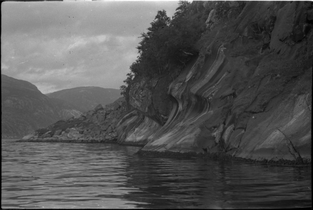 Bilder av skuringsstriper i bergene ved Vadla i Jøsenfjorden (bilde 1-4), Aslaug Skjold fra Sauda (bilde 5), Frida og Paul Johannessen på tur ved Indre Eidane i Jøsenfjorden (bilde 6-13), gården Vadla, ved Jøsenfjorden (bilde 14), Espedalen og Helle ved Høgsfjorden (bilde 15-17), en mann, muligens Erik Nesheim, som sitter utenfor hytta si på Helle (bilde 18-19) og sandtak på Vadla og sandterasse ved Ørekvam, nord for Vadla.