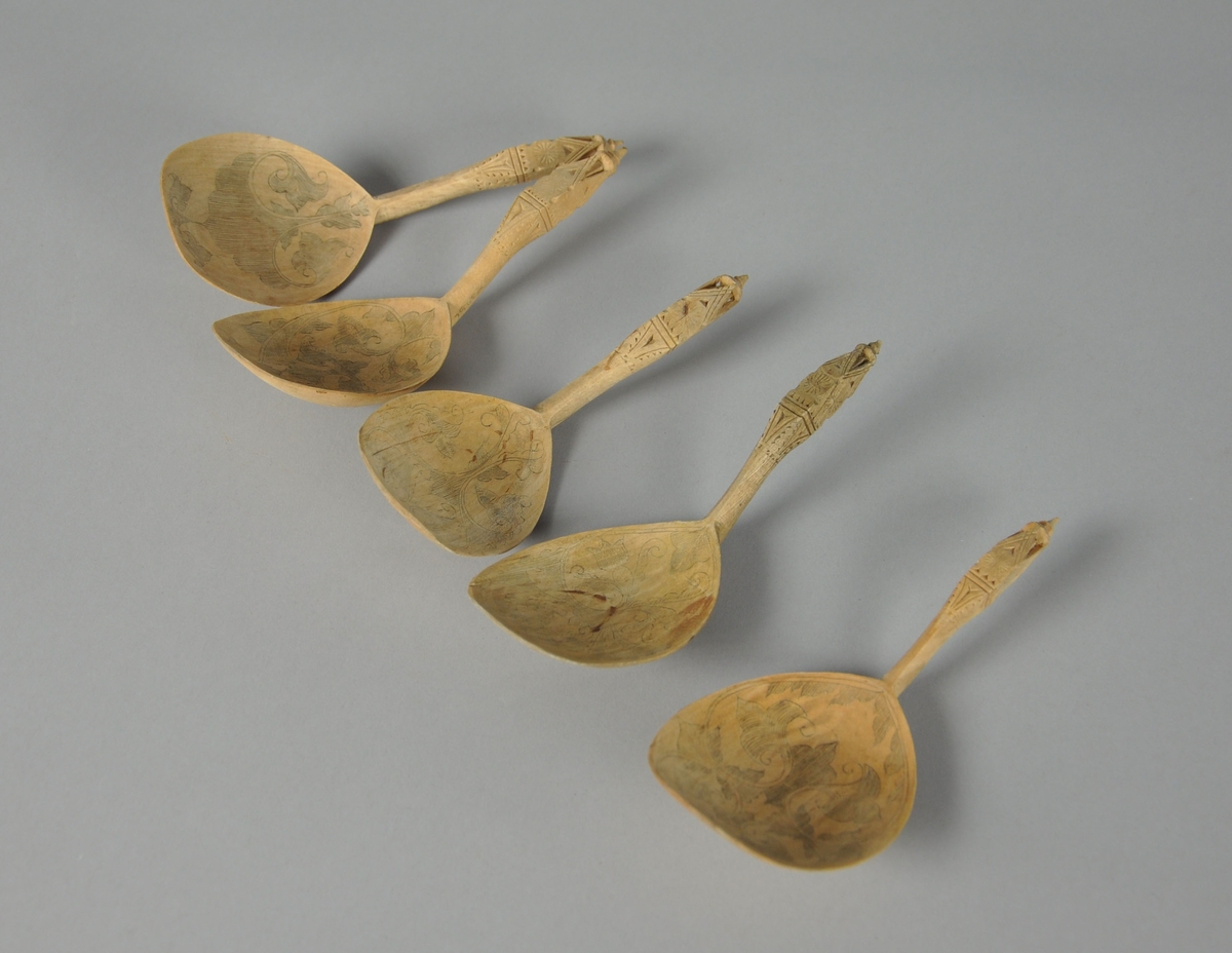 Skjeer av bjørk. Alle skjeene har bredt skjeblad med avflatet ende. Alle skjeene har skjeblad med ulik kolrosingdekor på oversiden. Skaftet på skjeene er buet og  og er dekorert med karveskurd.