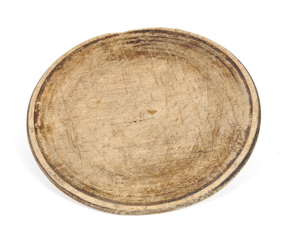 Tallerkner av dreid bøk. Sirkelrund med svak opphøyet ytterkant. Buemerke på ene siden.