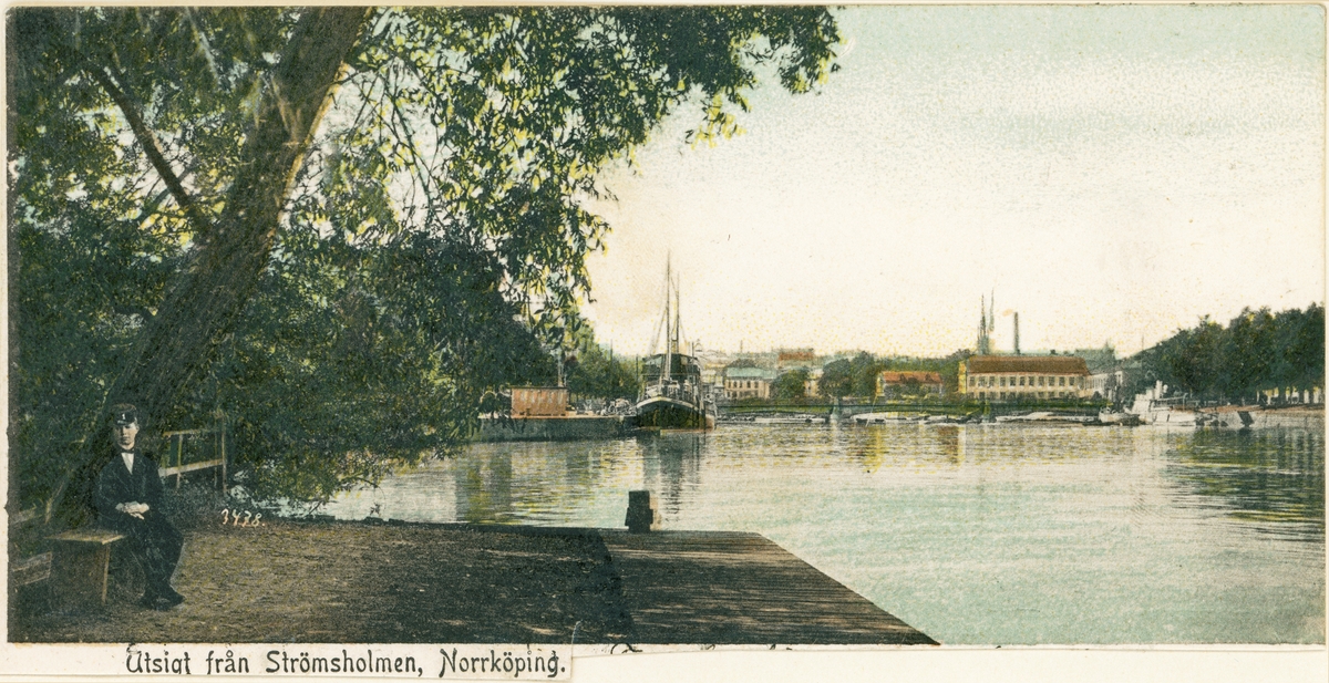 Vy från norvästra spetsen av Strömsholmen med blick ut över Motala ström mot Oskar Fredriks bro och bebyggelsen vid Karl Johans park. I fonden skymtar Matteus kyrktorn. Kolorerat vykort. Vy mot väster.