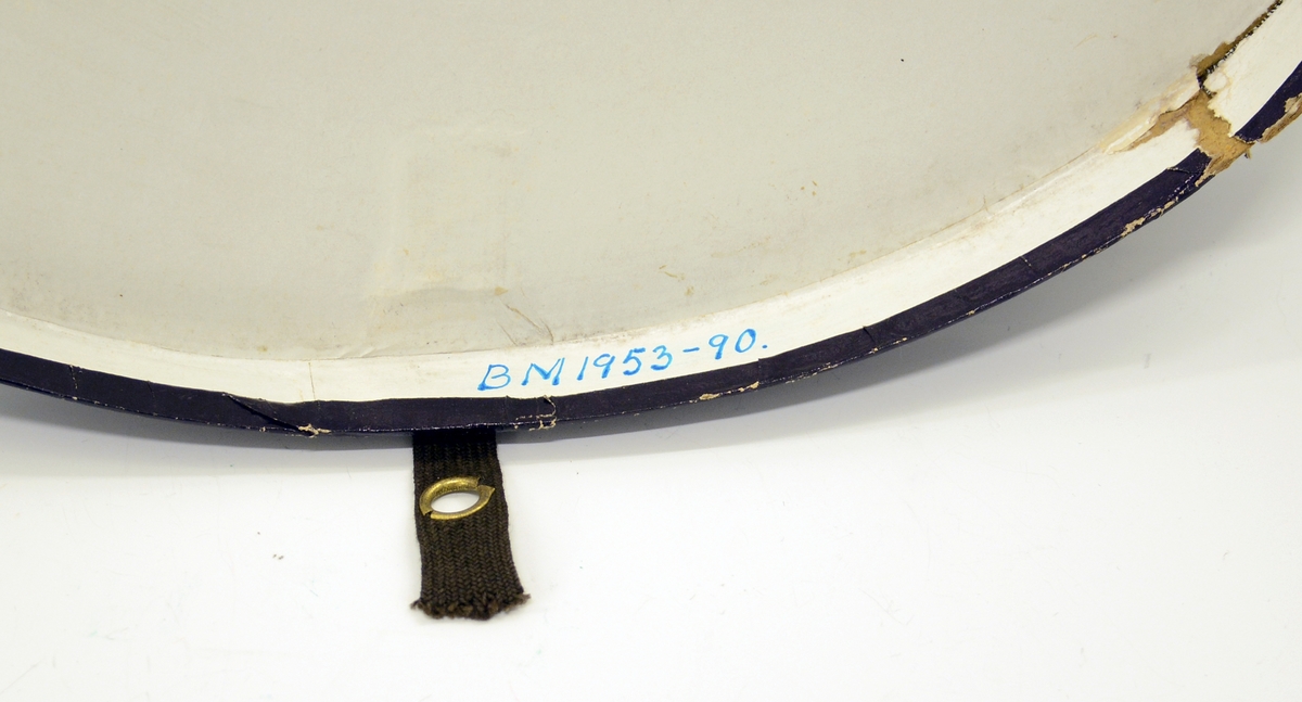 Flosshatt med etui. Sort, sammenleggbar flosshatt eller Chapeaux claque. Silketrukket papp med bånd nederst. Monogram HI med metallbokstaver innvendig. Ovalt etui i brun papp med påskrift i gull: "MANUFACTURE DE PARIS CHAPEAUX MÉCANIQUES PERFECTIONÉS", samt våpenskjold med blant annet skip i midten. Strikk og metallfester på sidene. Kjøpt av firmaet L.H.van Hees, München. Fabrikkert av Giraud, Paris.