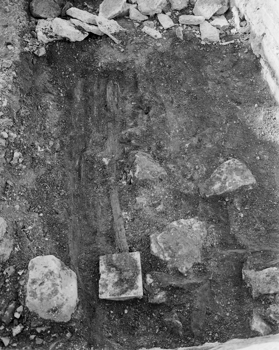 Arkeologiske undersøkelser i kjellerruin vest for drengestua 1986-1989. Deler av tregulv under utgravning 1988.