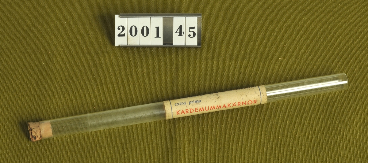 Glasrör som ettiketten innehållit extra prima kardemummakärnor
