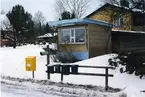 Karbenning sn, Karbenning.
Kioskbyggnad i Karbennings stationssamhälle, 1999.
Gul postlåda, gröna brevlådor och VLT tidningsrör.