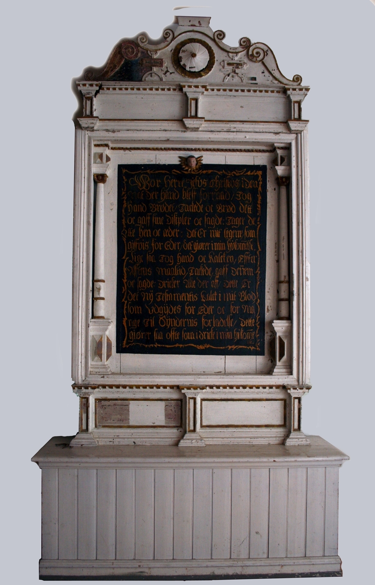 1) Predella   Eik. 
På fronten to liggende rektangulære fyllinger.  
Predellaen er fastmontert på et postament  ("alterbord") i furu.  
Ca. 1900 Hvitmalt, predellen med marmorert gulbrun "gull" staffering.  

2) Altertavle (alterskap-dørene mangler).  Eik. 
Tekstfelt sortmalt med gullskrift:   

3) arkitrav. Eik. 
Fronten inndelt i to liggende felter. På hjørnene  og på midten forkrøppede "bjelkelag". Tannsnitt i  øvre list.  

4) Bekroning. Eik.   
Svungent toppstykke og C former i konturen. Stort sirkelrundt rosett med dukatbord om pm. Beslag  ornamentikk flankerer. Opprullet voluttende på  toppen (virker malpiassert ifgl. UH). Har spiker for  feste av 5). 
 
5) Due, N T S M 1781. Furu, malt gulbrun og gul  imitasjon av forgylling. 
Grovt skåret guLt med palmett over hodet, ut  slåtte vinger og på oversiden av halen innskåret:  N T S M 1781. Midt på ryggen en krok av jern.  Denne tilhører døpefonthimlingen, som er oppbevart i kirken.

1) Predella   H. 37,5. L. 151,5. B. 29,5. 
 postament under predellaen  H. 72,5. L. 185. B. 58.  
2) Altertavle  H. 163. B. 142. 
3) arkitrav.  H. 29. L. 149. B. 29. 
4) Bekroning.  L. 148. H. 49. 
5) Due,  L. 30,5. B. 30,5