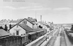 Eskilstuna Central stationshus med persontåg vid plattform.