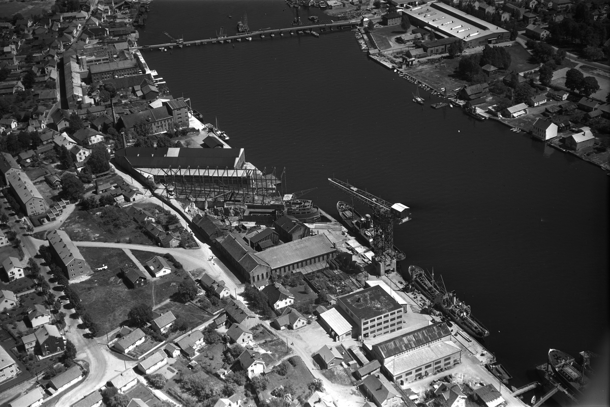 Flyfotoarkiv fra Fjellanger Widerøe AS, fra Porsgrunn Kommune. Porsgrunn Mekaniske Verksted. Ser også den gamle Porsgrunnsbrua. Fotografert av Vilhelm Skappel, 18.06.1955.