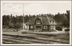 Spårsida av station med del av perrong i bild.