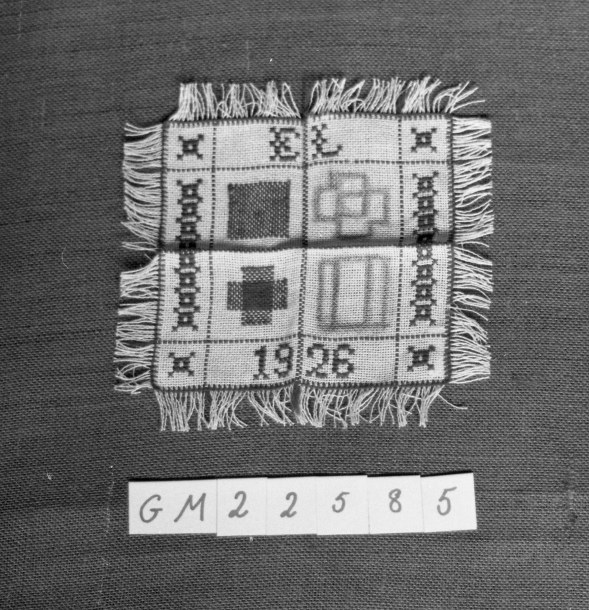 Tøylapp med frynser, dekorert med korsstingsbroderi