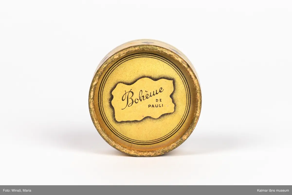 KLM 46157:205. Puderdosa. Pappdosa med rosa rouge inuti. Text: Bohème PUDER F. Pauli.