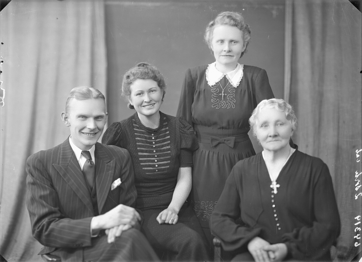 Portrett. To foto med lyshåret eldre kvinne i mørk kjole med perleknapper i front. Kors om halsen. Gruppebilde. Familiegruppe på fire. Fire foto med ung lyshåret mann i mørk stripet dress, mørk vest, hvit skjorte og mørkt slips, ung mørkblond kvinne i mørk mønstret kjole med hvite striper og hvite knapper i front, ung mørkblond kvinne i mørk kjole med broderinger i front og hvt krage. Lyshåret eldre kvinne i mørk kjole med perleknapper i front. Kors om halsen. Bestilt av Fru Serine Dybdal Henriksen.