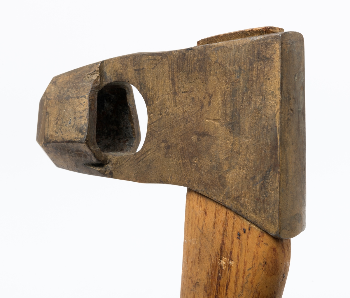 Øks - brukt til merking av fløtingstømmer i målings- og annammingsprosessen som foregikk langs vassdragene i overgangsfasen mellom vinter og vår, da tømmerstokkene etter måling formelt skiftet eier - fra skogeieren som hadde organisert hogst og framkjøring til sagbruk eller treforedlingsbedrift, som kjøpte tømmeret med sikte på videre bearbeiding til produkter som var salgbare på et større marked. 

Øksehodet (den smidde delen) er 13,1 centimeter høyt fra eggpartiet til nakken. Nakkedelen er 8,2 centimeter lang og om lag 2,5 centimeter bred bakerst, 2,2 centimeter i fronten. «Kjakene» - sideveggene rundt «øyet» (skafthullet) – smalner fra nakkepartiet mot den nedre delen av bladet. På den nedre delen av øksebladet er det en U-formet utsparing, og til endestavene (Knudsen-smedene kalte dem «stabler») er det påsveiset en cirka 3,8 centimeter høy fasslipt, profilegget «sko». Eggprofilen er en noe avlang åttekant (oktogon). Dette symbolet ble altså slått inn i yteveden på fløtingstømmeret, som tegn på hvem som eide stokkene. Øksehodet er, med unntak av den fasslipte eggen, lakkert med gulfarget lakk. Denne øksa har ikke noe smedstempel, men form og overflatebehandling tyder på at den er produsert av smeden Karl Henrik Knudsen (1870-1956) i Mjøndalen i Nedre Eiker.

Denne øksa har et 61 centimeter langt og forholdsvis rett treskaft (sannsynligvis ask eller hickory). Som økseskaft flest er det bredest i høyderetningen og smalest i bredderetningen i den fremre enden, og mer rundovalt bakerst. Den fremre enden av skaftet er kilet med en trekile som skulle redusere faren for at øksa løsnet fra skaftet under merkingsarbeidet.

Ifølge «Merkekart 1953 for Glommen» (gjengitt i Julius Nygaards skogalmanakk for 1954) ble dette merket brukt av Fetsund lenser i Glommavassdraget (jfr. merke nr. 35).

Litt generell informasjon om bruken av merkeøkser i skogbruket finnes under fanen «Opplysninger».