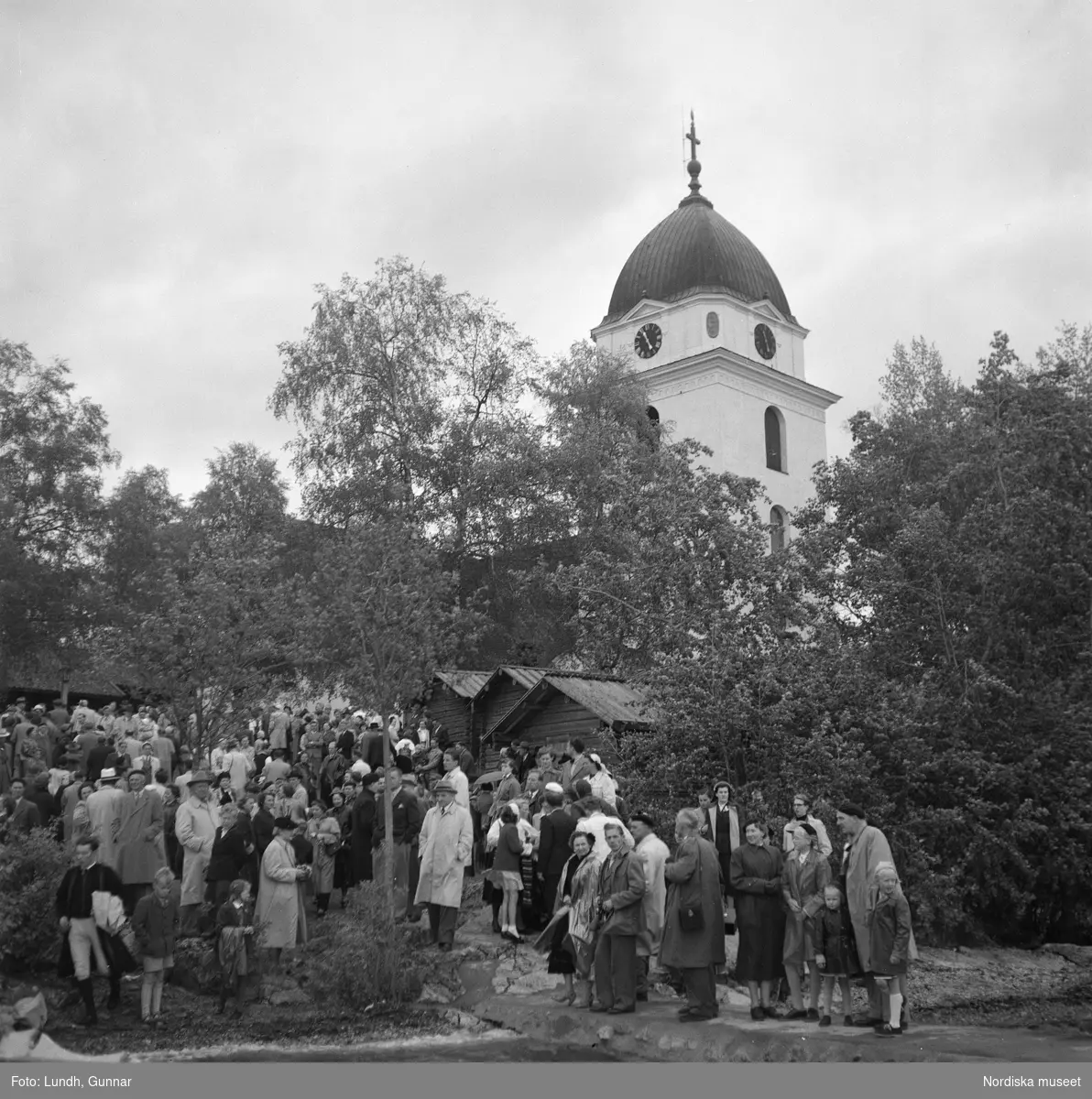 Motiv: (ingen anteckning) ;
En man i folkdräkt står i en kyrkbåt, en folksamling står vid Rättviks kyrka, utsikt genom ett fönster med människor som går på en väg, interiör av en kyrka med besökare, en person tar upp kollekt.