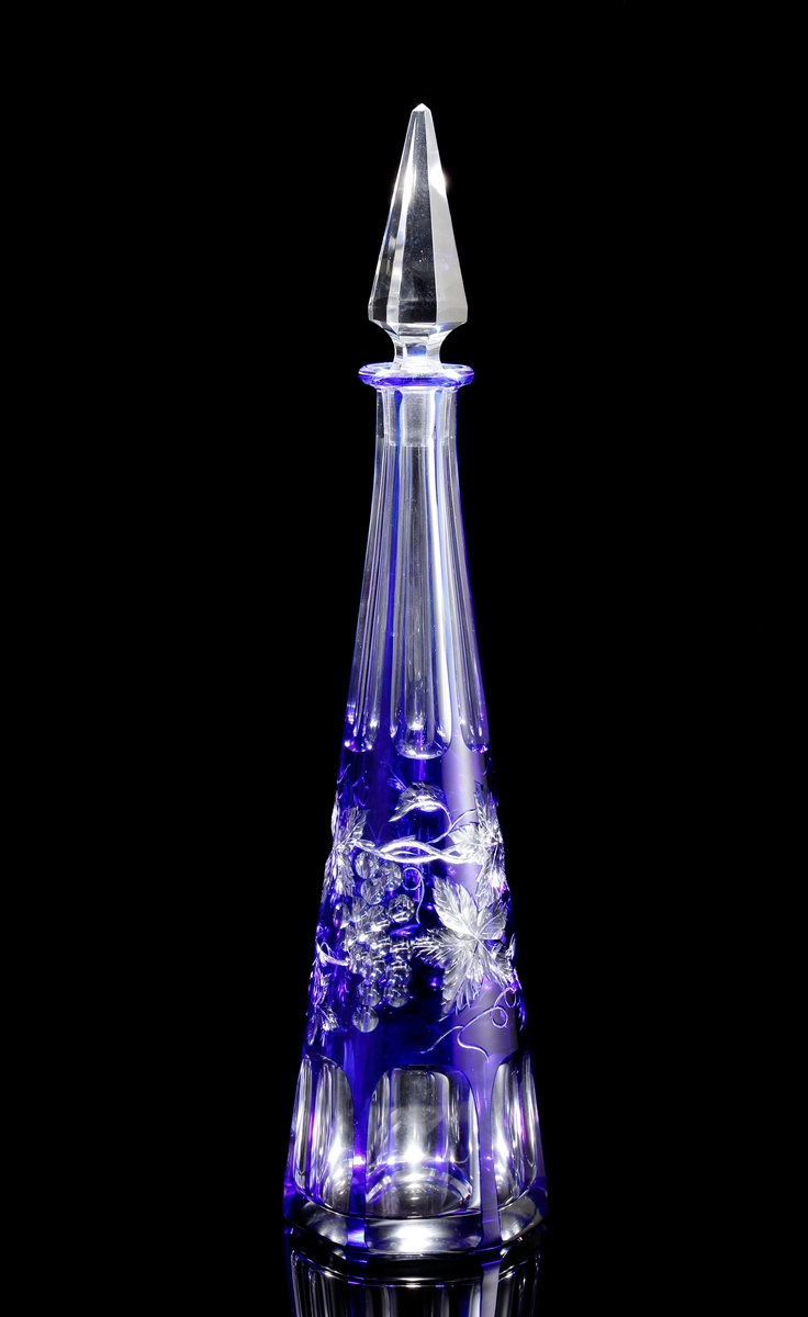 Karaff med blått överfång. Slipad dekor med vinrankor samt facettslipade partier.